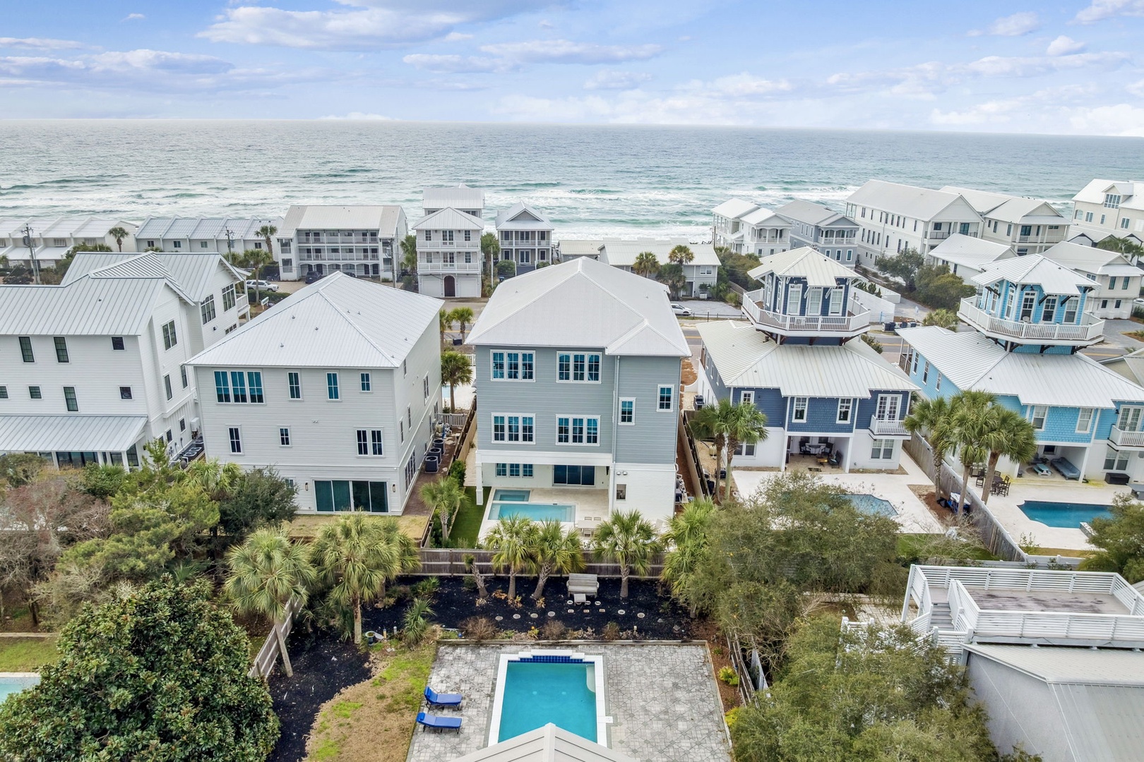 Coastal community of elegant vacation homes featuring swimming pools, just steps from pristine white sand beaches and emerald waters.