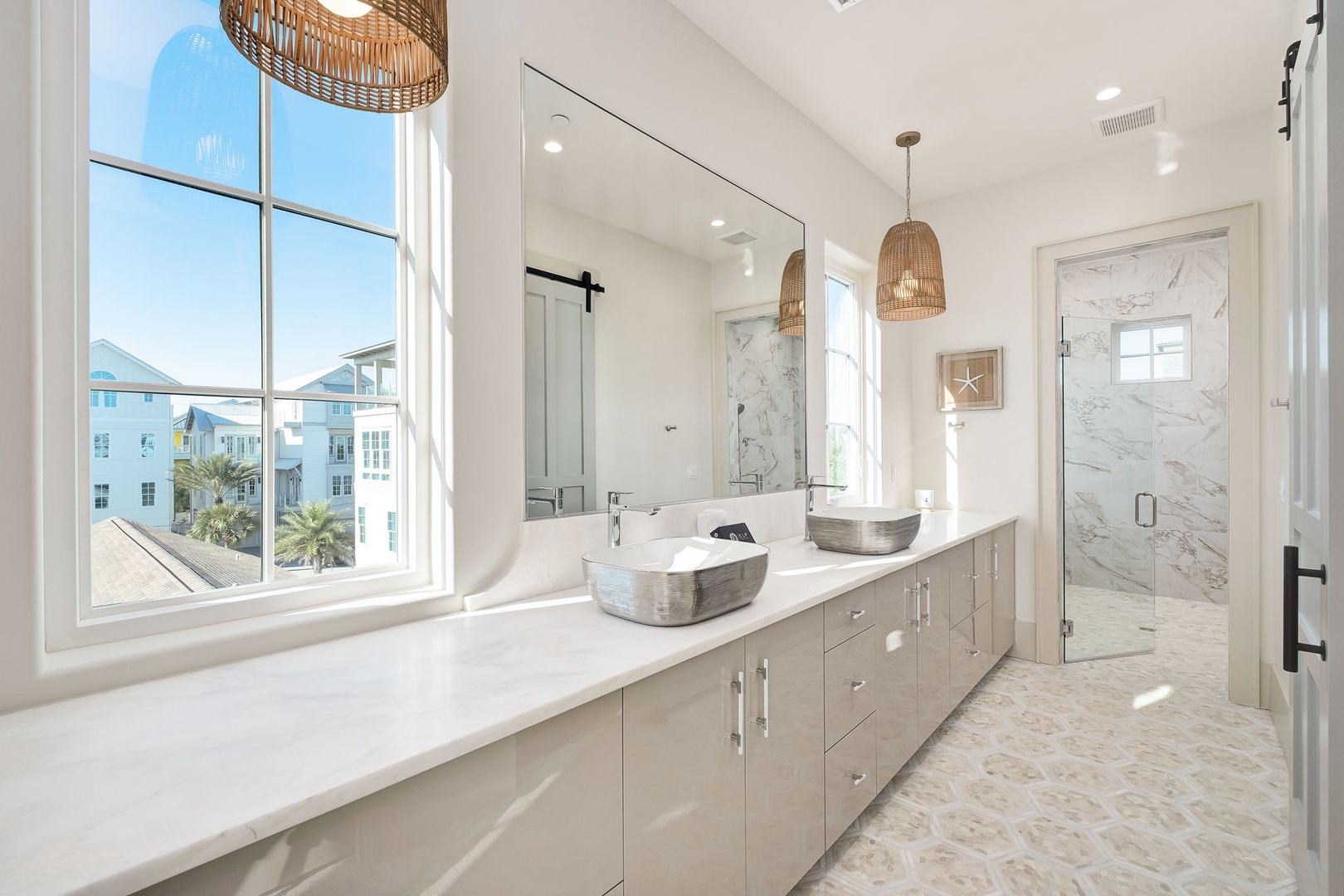 Luxurious bathroom with marble finishes, dual vessel sinks, and natural wicker pendant lights creates your perfect morning routine sanctuary.