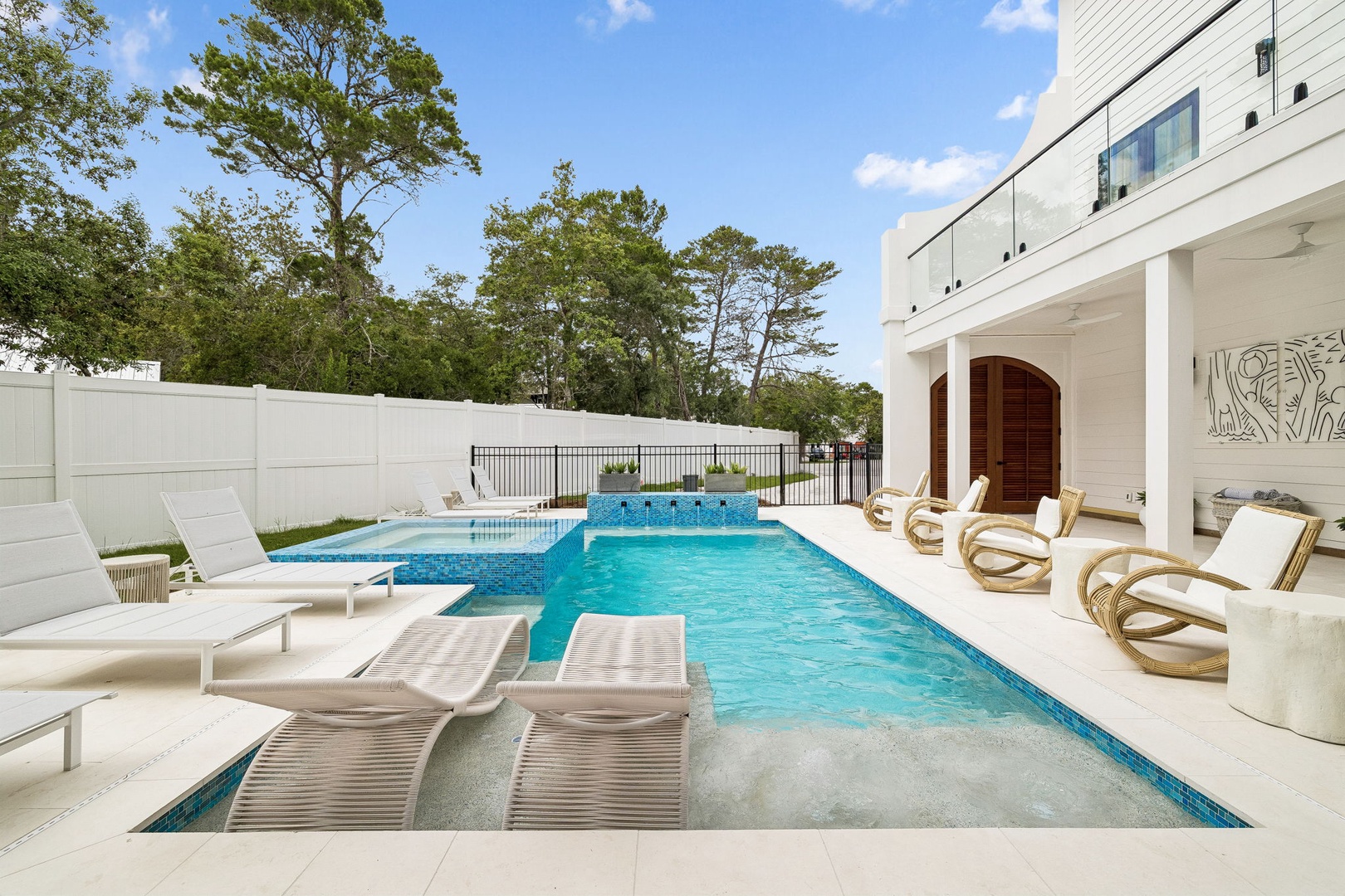Dip into your private pool with shallow lounge ledges and sun-soaked deck—perfect for unwinding under open skies with lush trees as your backdrop.