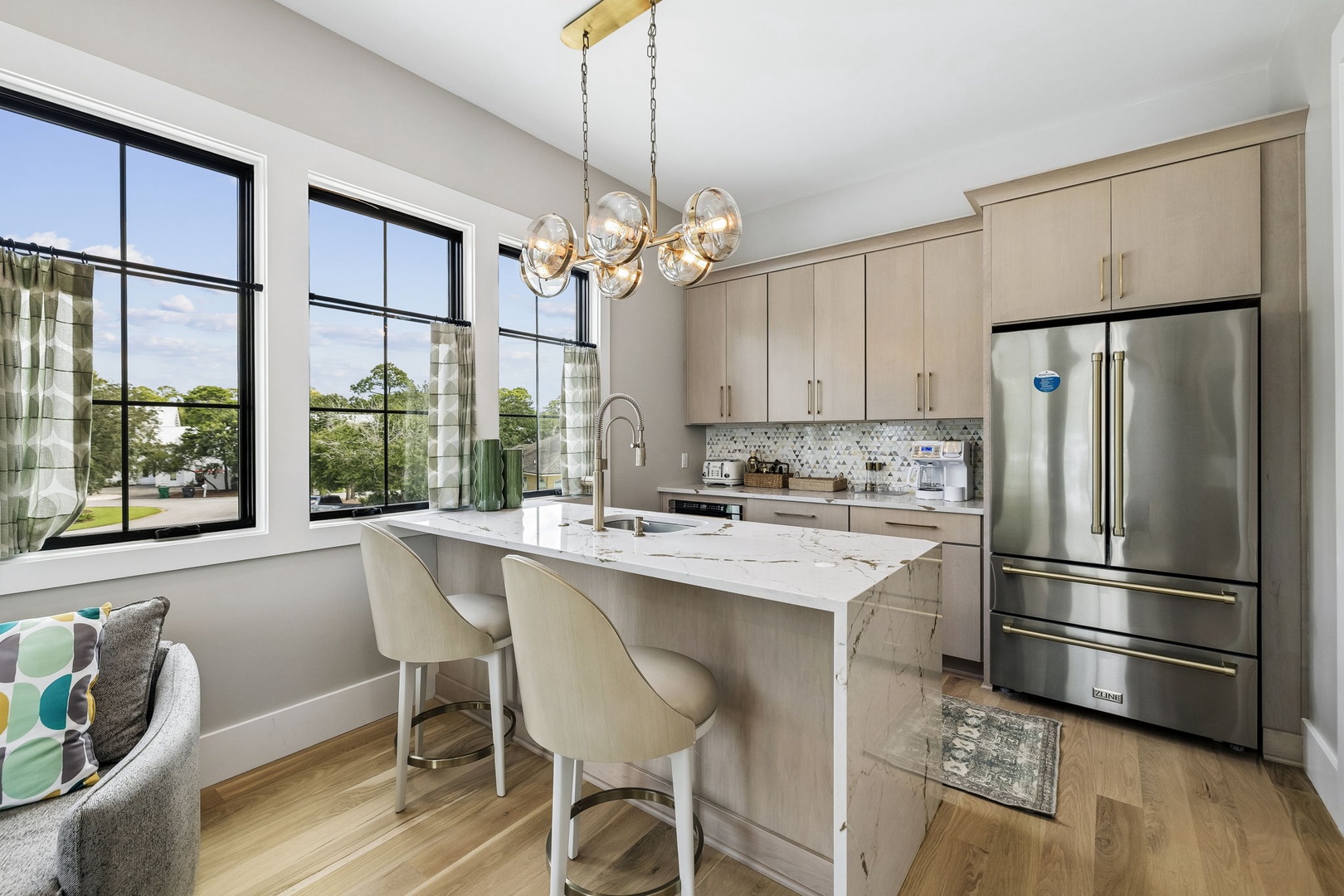 Cook, gather, and soak in the natural light streaming through oversized windows. Your modern kitchen features elegant marble countertops, stainless steel appliances, and a central island perfect for morning coffee or evening wine.