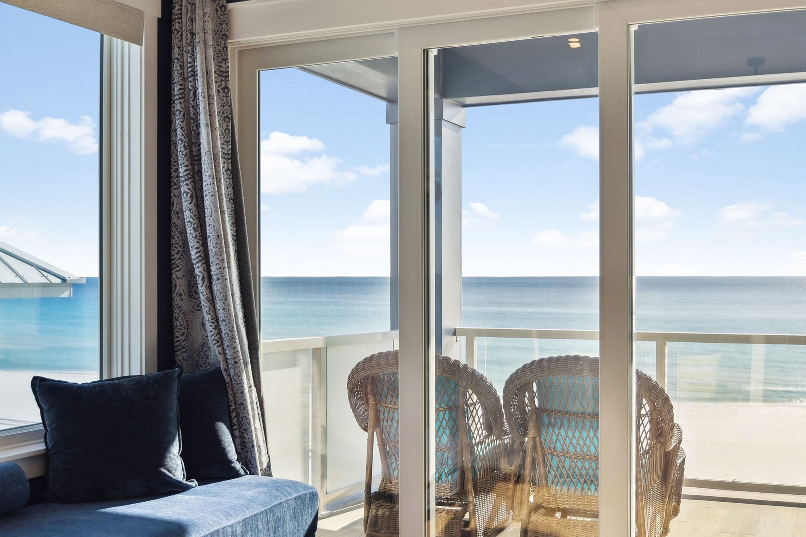 Relax in your comfortable living space while gazing at stunning ocean views through floor-to-ceiling windows that lead to your private balcony.