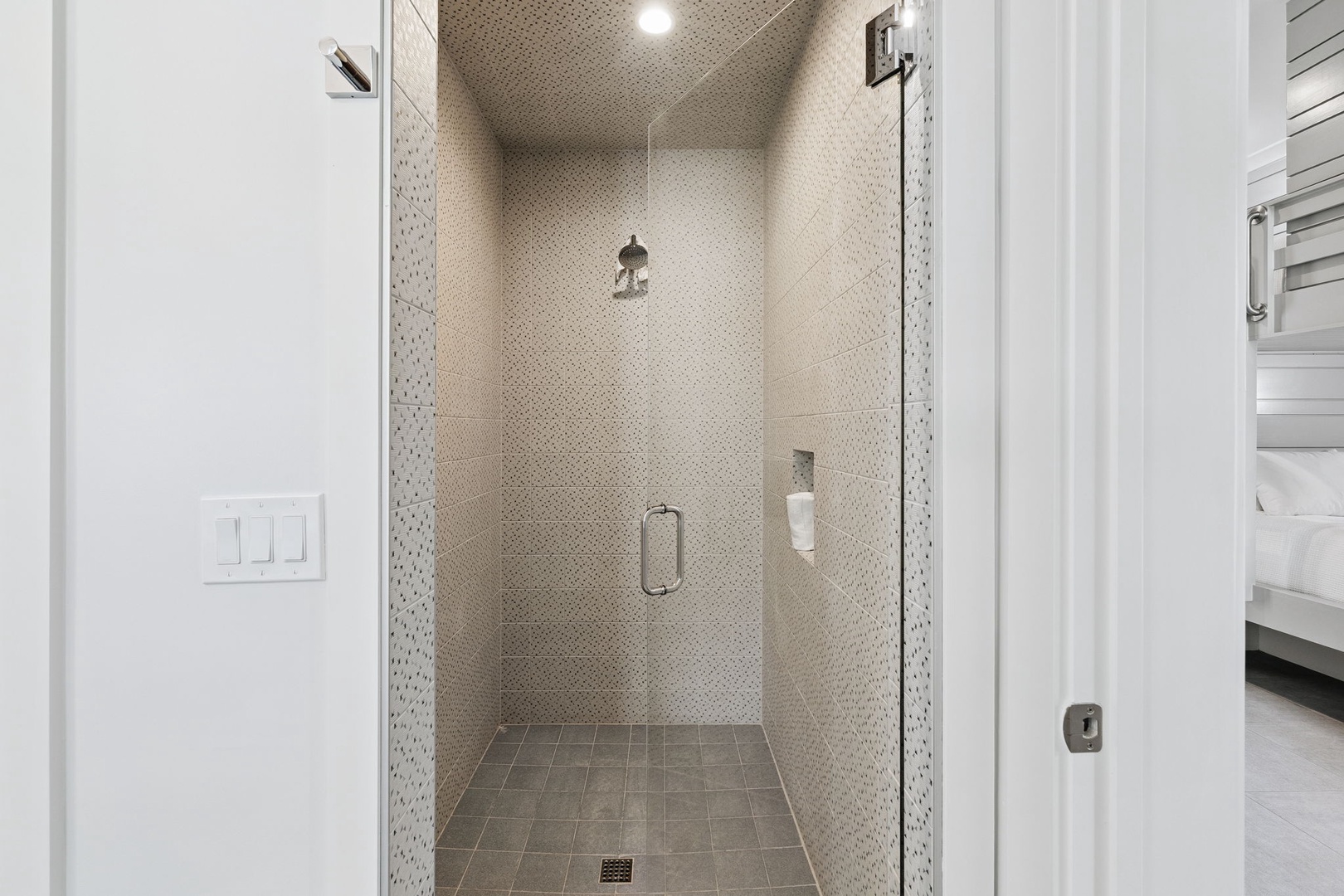 Step into your private tiled shower sanctuary, where modern fixtures and sophisticated design create the perfect space to refresh after your adventures.
