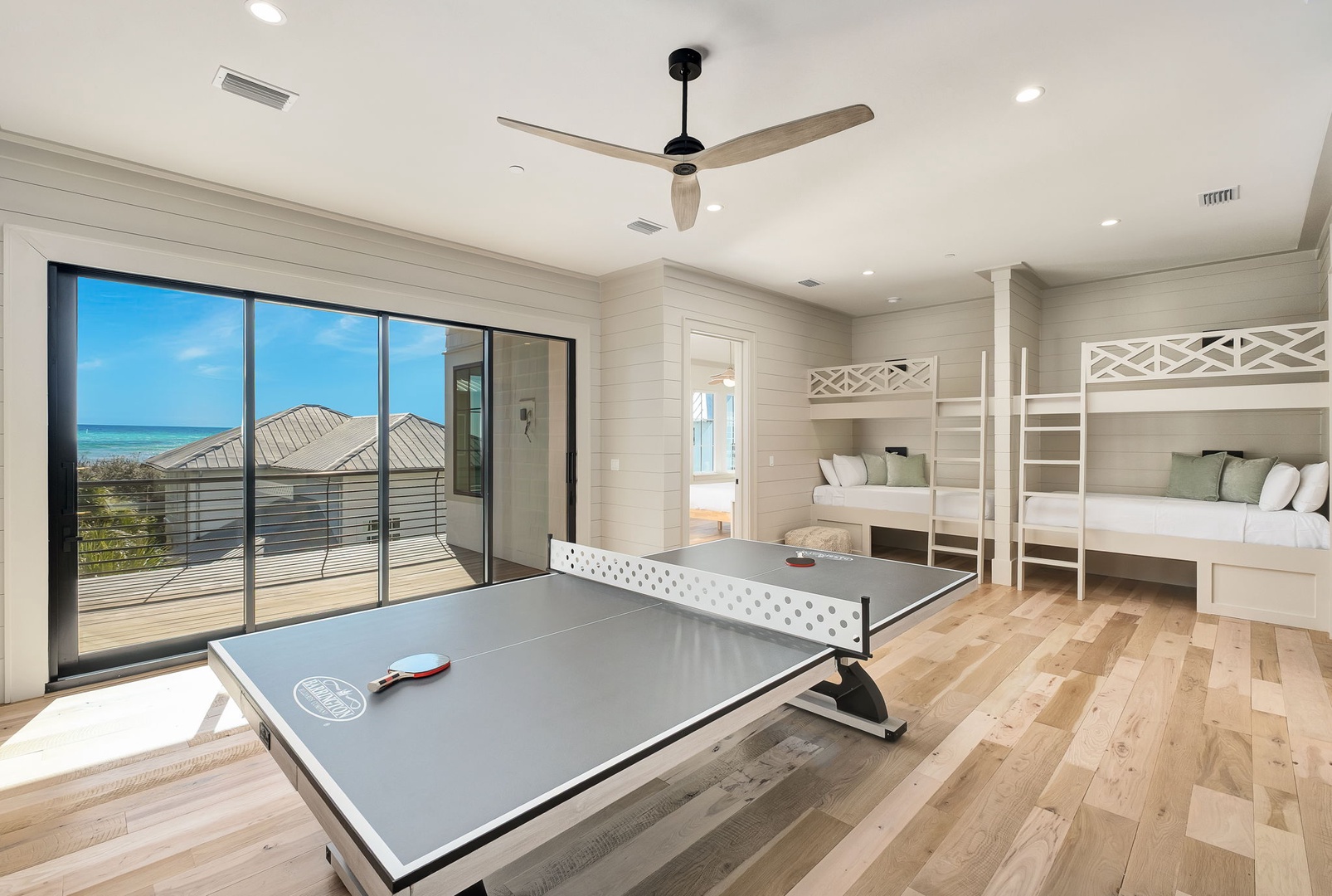 Your kids will love this fun bedroom with custom bunk beds and ping pong table, plus stunning ocean views through floor-to-ceiling windows.