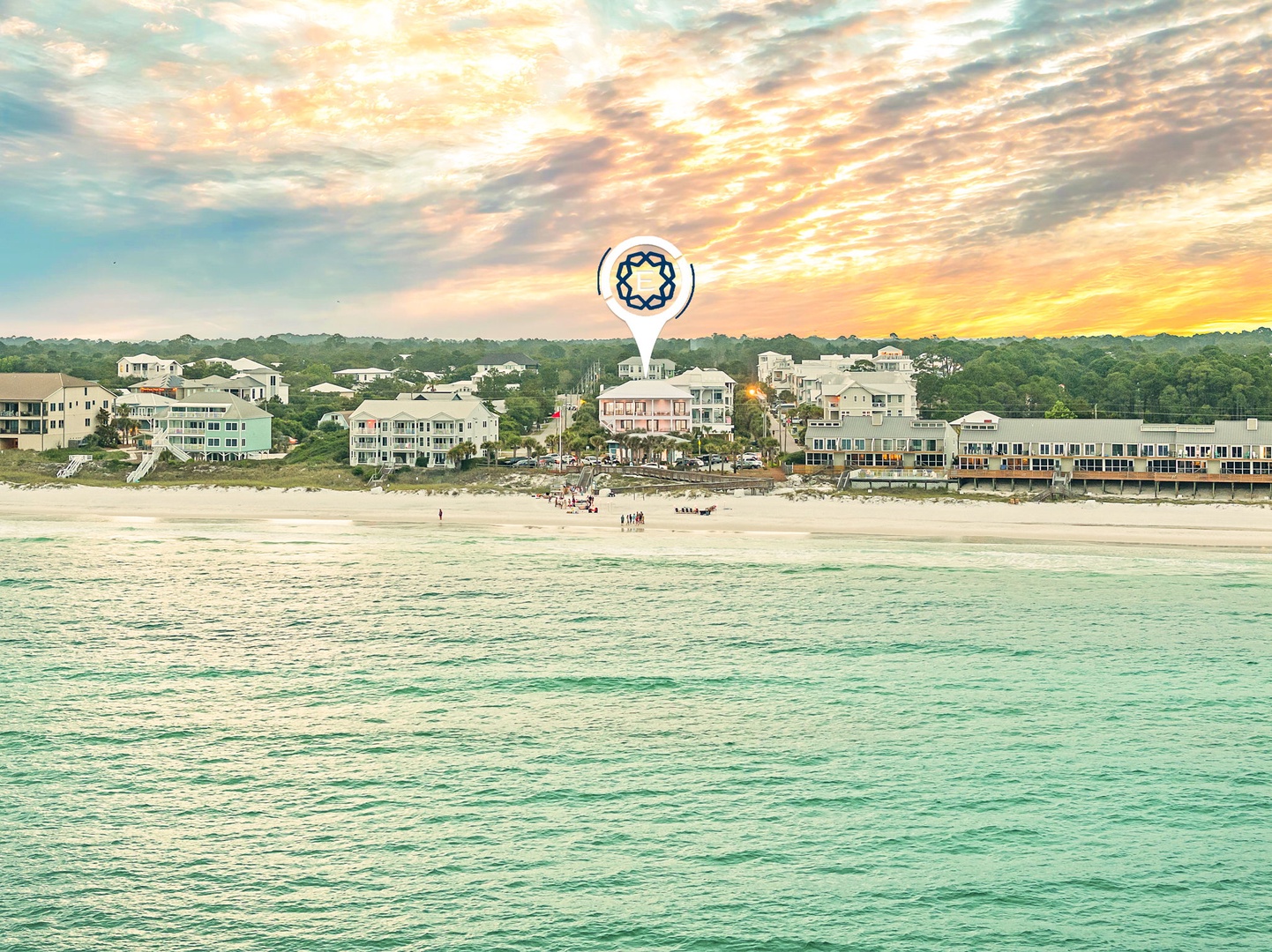 Beachfront properties line a pristine stretch of turquoise waters under a breathtaking sunset sky, showcasing the property's idyllic coastal location.