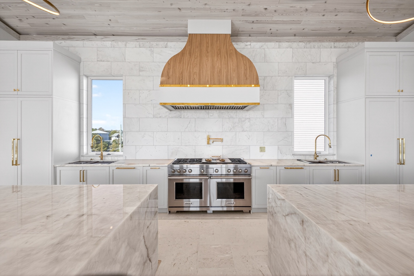 You'll love cooking in this stunning chef's kitchen with marble countertops, professional-grade appliances, and warm wood accents.