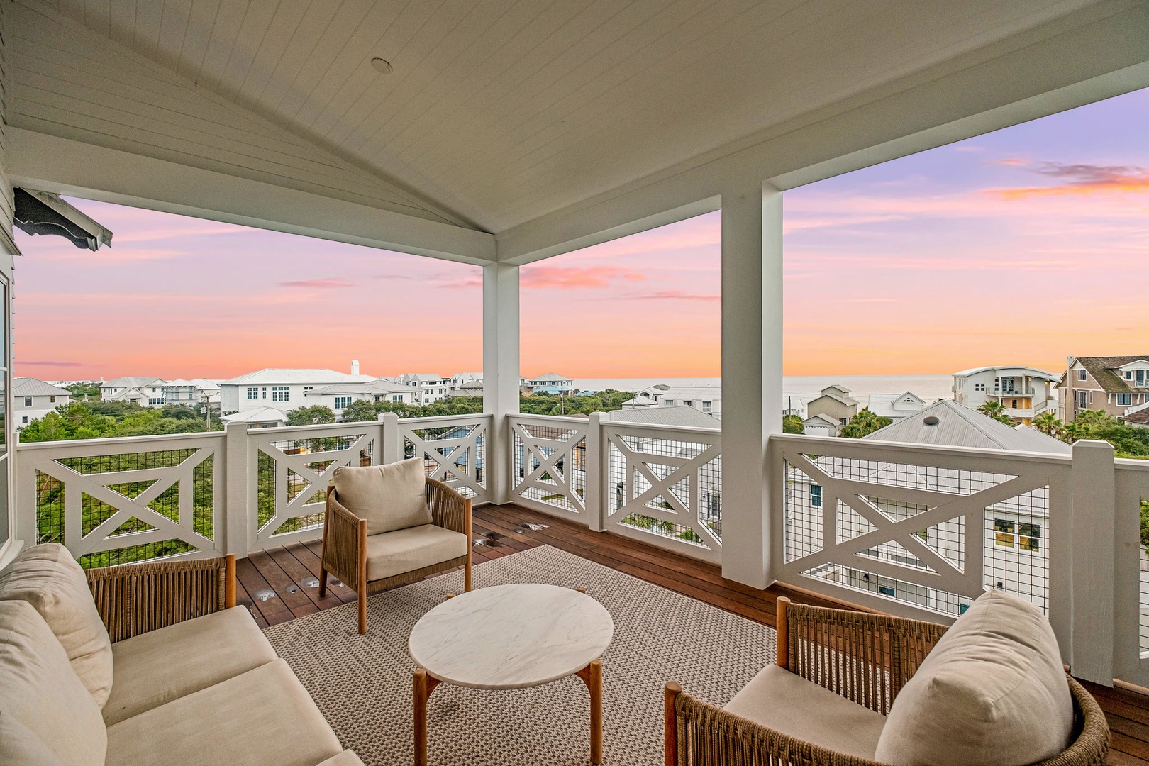 Settle into your private covered balcony with plush seating and watch the sunset paint the sky in soft pastels. A peaceful retreat with coastal neighborhood views and gentle ocean breezes.