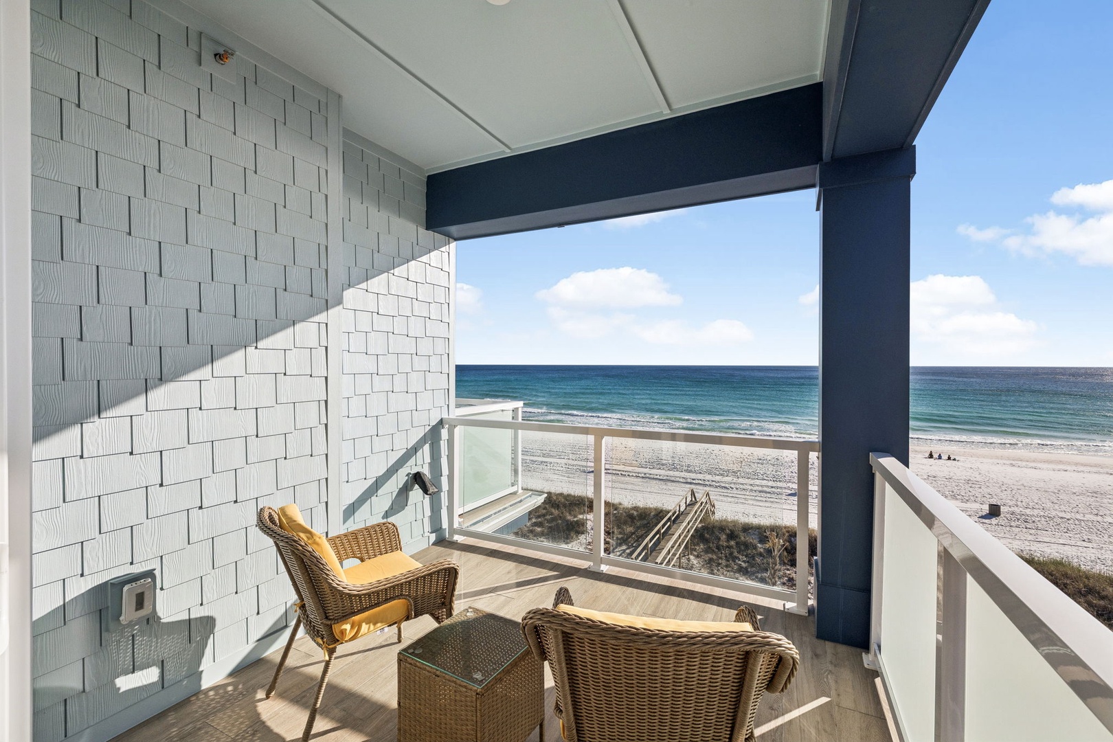 Wake up to stunning ocean views from your private balcony, where comfortable seating awaits your morning coffee and endless beach moments.