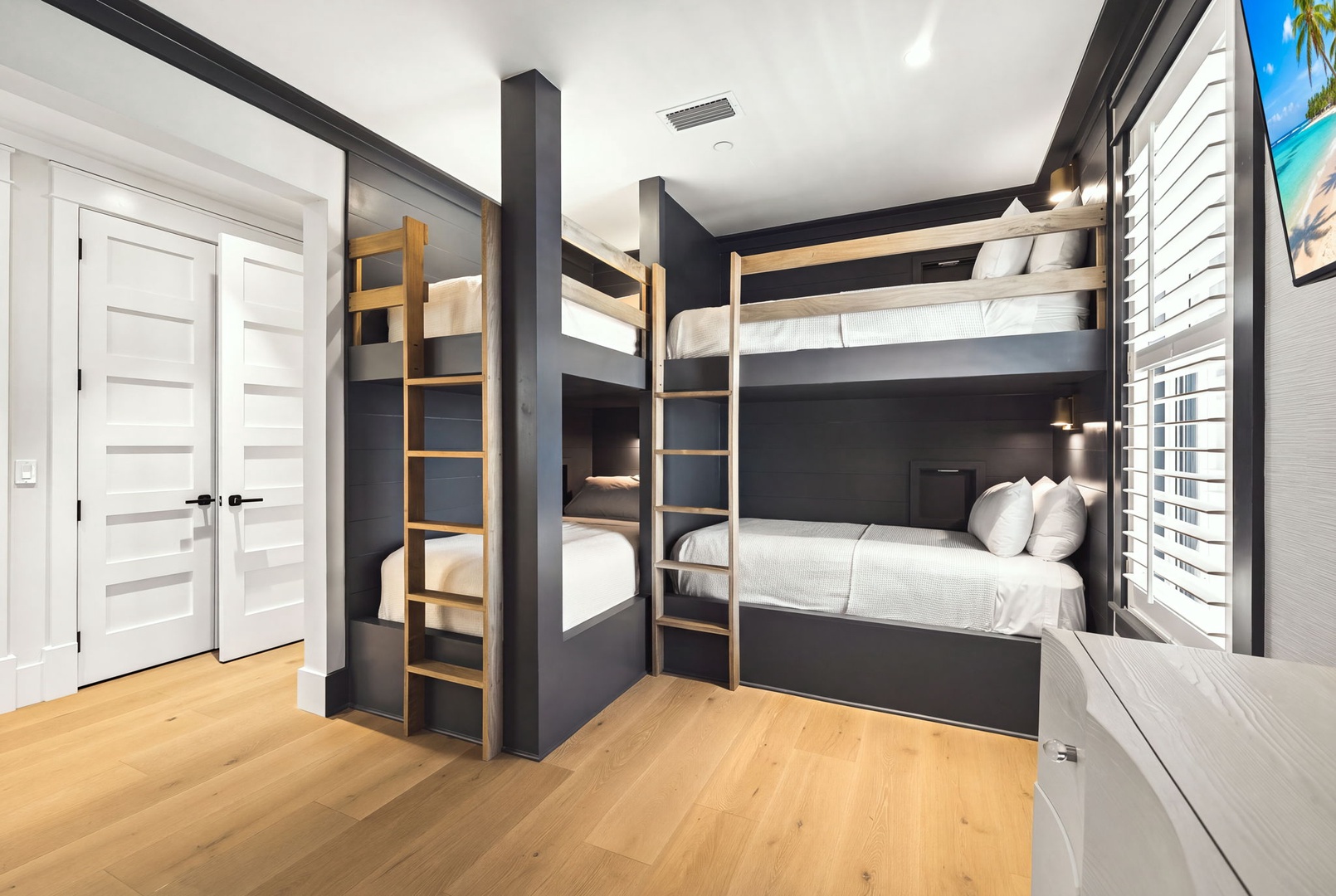 Your stylish bunk room features custom-built beds with crisp linens and modern lighting. Perfect for families or groups, this sleek space makes shared accommodations feel like a restful retreat.