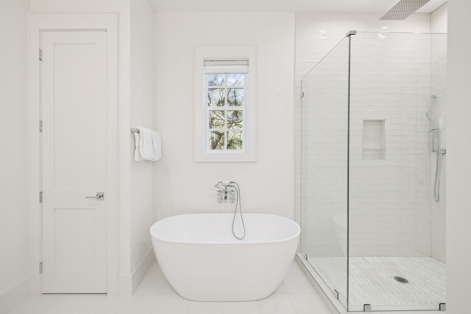 Unwind in your spa-like bathroom featuring a luxurious soaking tub and rainfall shower with elegant marble finishes throughout.