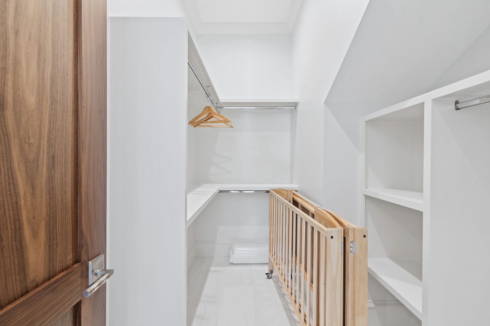 Clean, organized storage space with wooden hangers and shelving keeps your belongings perfectly arranged throughout your stay.