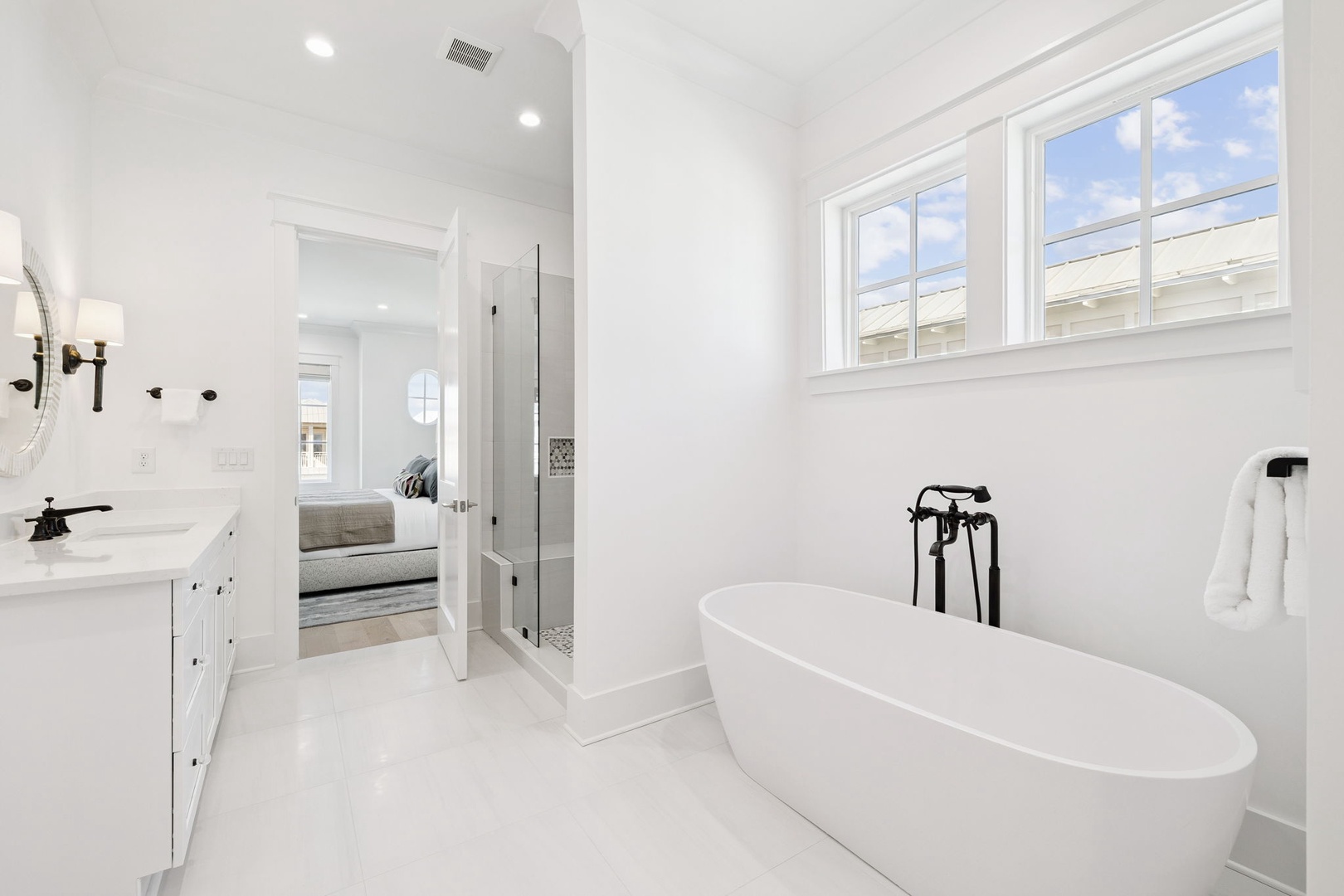 Unwind in your pristine ensuite with a luxurious soaking tub and elegant shower, where crisp white finishes create a spa-like retreat.