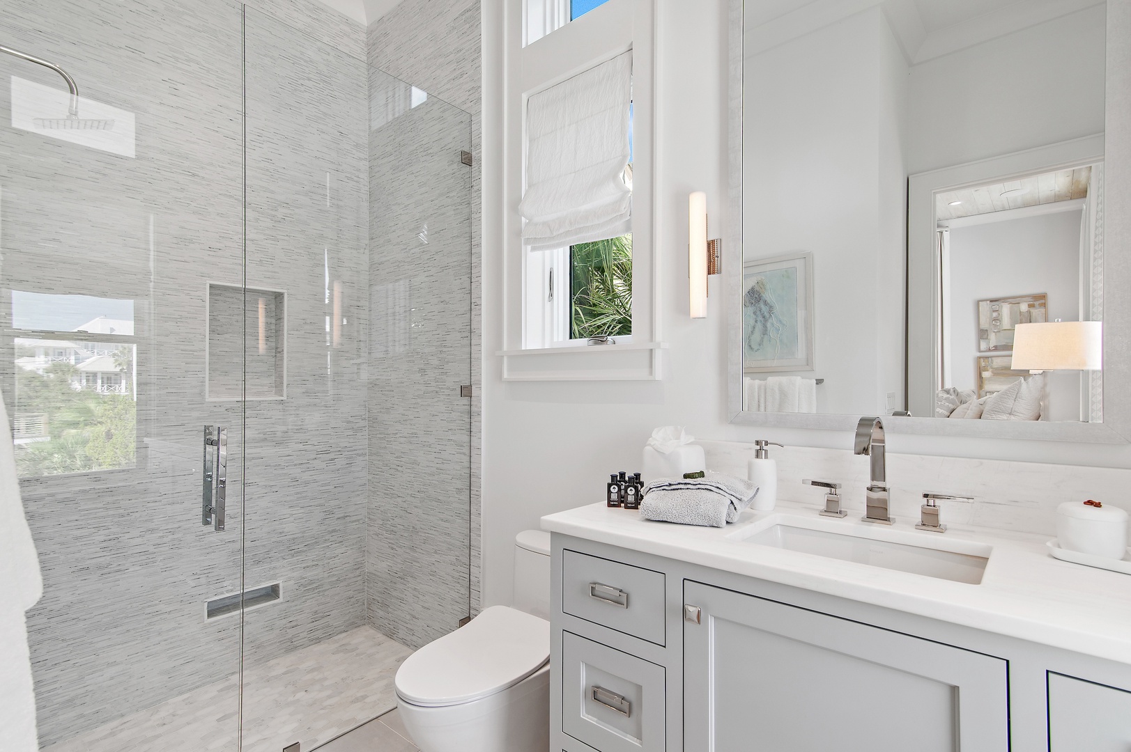 Step into your elegant spa-like bathroom, featuring a spacious glass-enclosed shower and sleek custom vanity with premium finishes. Soft natural light fills the space for your refreshing morning ritual.