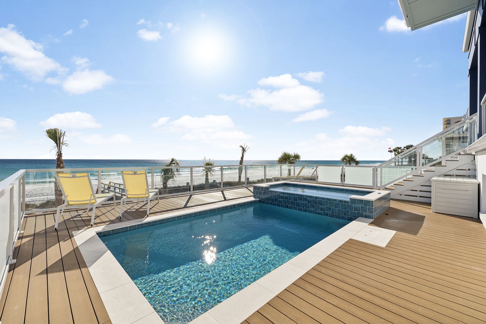 Step onto your private deck where sparkling pool waters meet ocean views, creating the perfect beachfront escape.