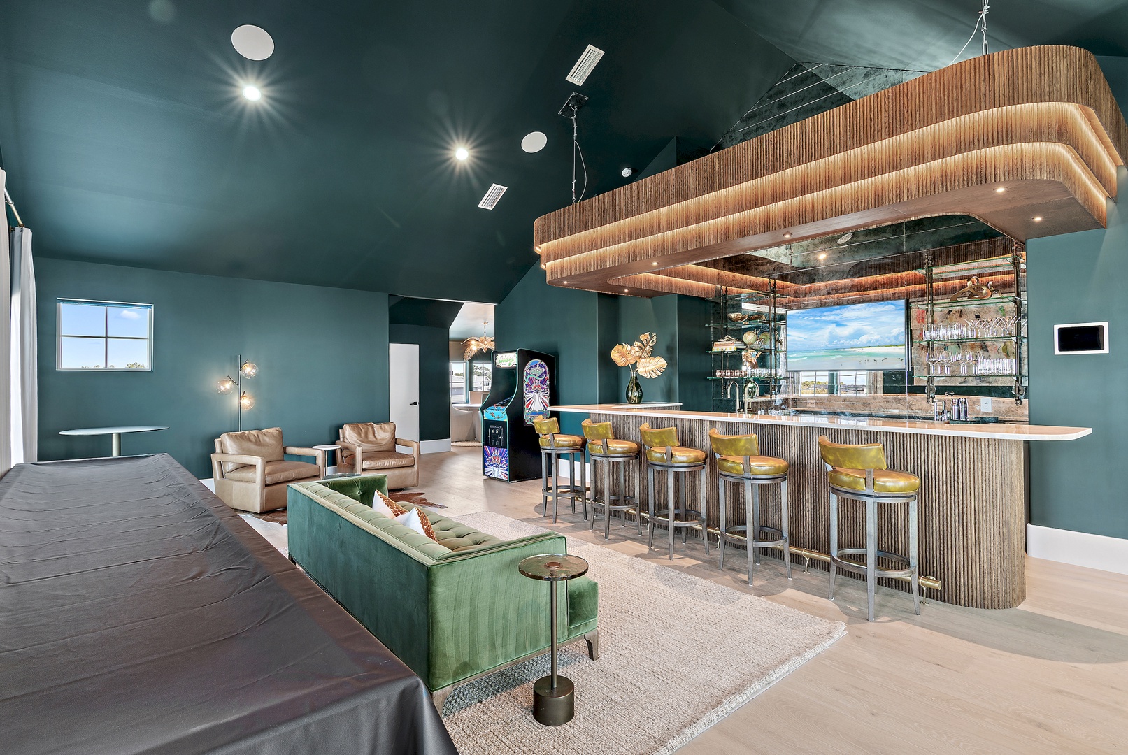 Your social space features a stunning bar with wraparound seating, plush velvet lounges, and warm lighting—perfect for evening cocktails or friendly gatherings.