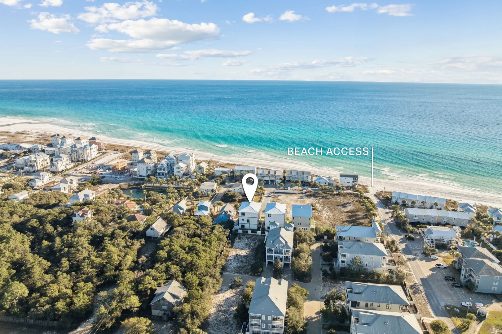 Stunning beachfront community with pristine white sand beach and turquoise waters just steps away from residential properties.