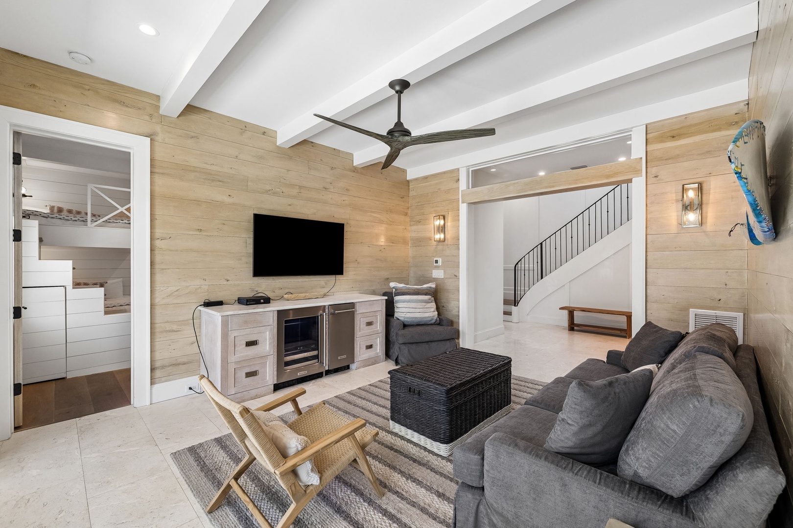 Relax in your stylish living space with a cozy sofa, smart TV, and chilled beverages at your fingertips. Coastal touches and airy vaulted ceilings create the perfect beach retreat.