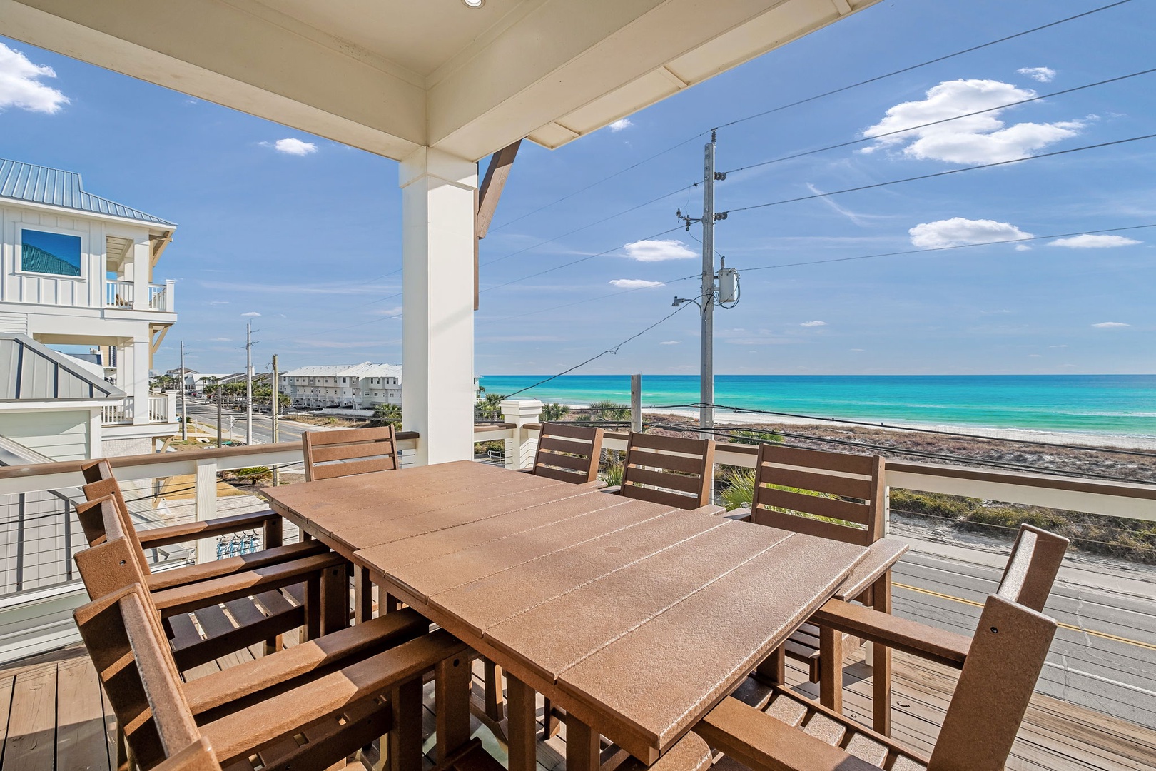 Your private covered dining deck features ocean views and beach access steps away, perfect for memorable meals with the sound of waves.