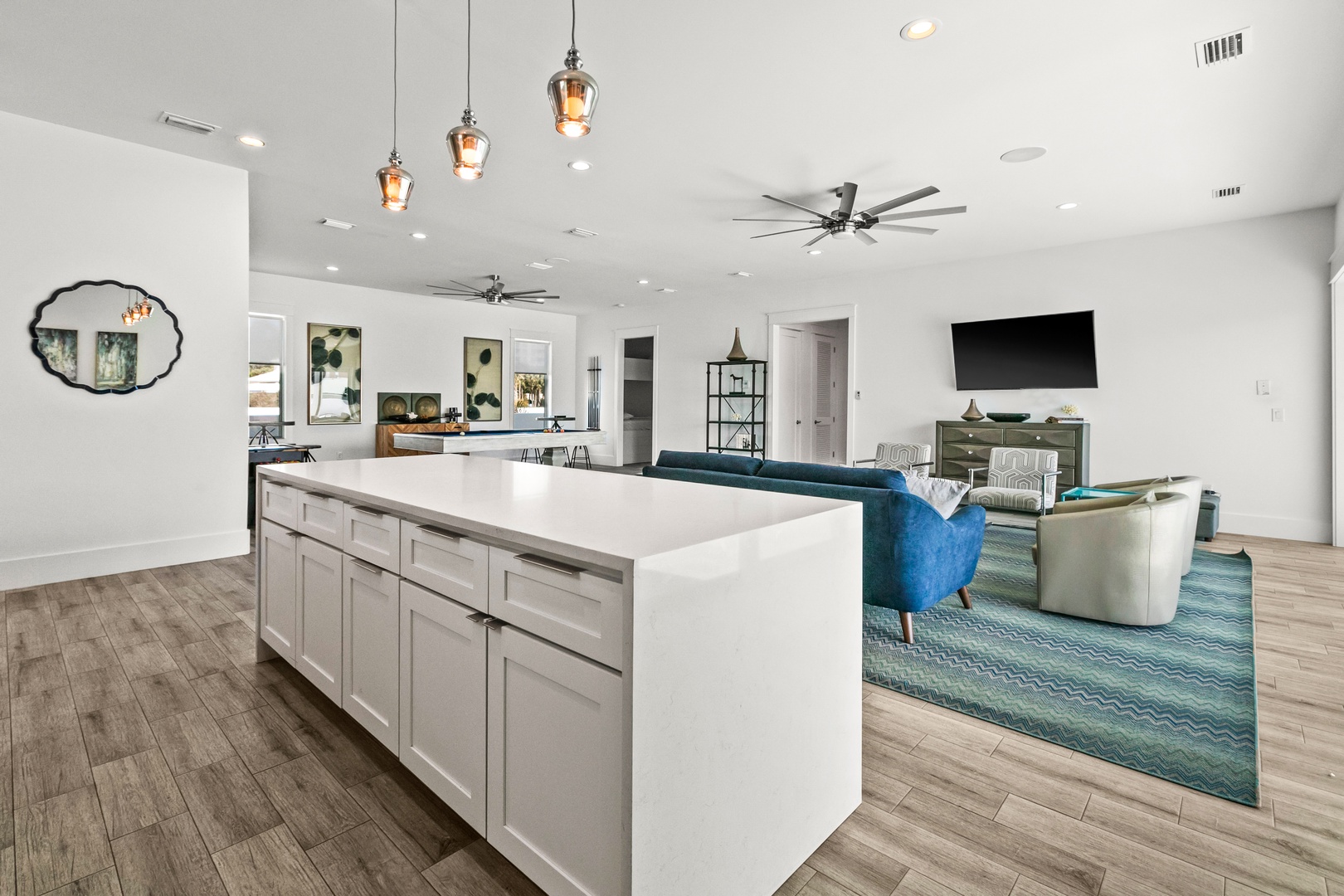 Step into your open-concept retreat where the kitchen flows seamlessly into the living area. Gather around the spacious island, relax on plush seating, and enjoy your favorite shows—all in a bright, airy space designed for making memories.