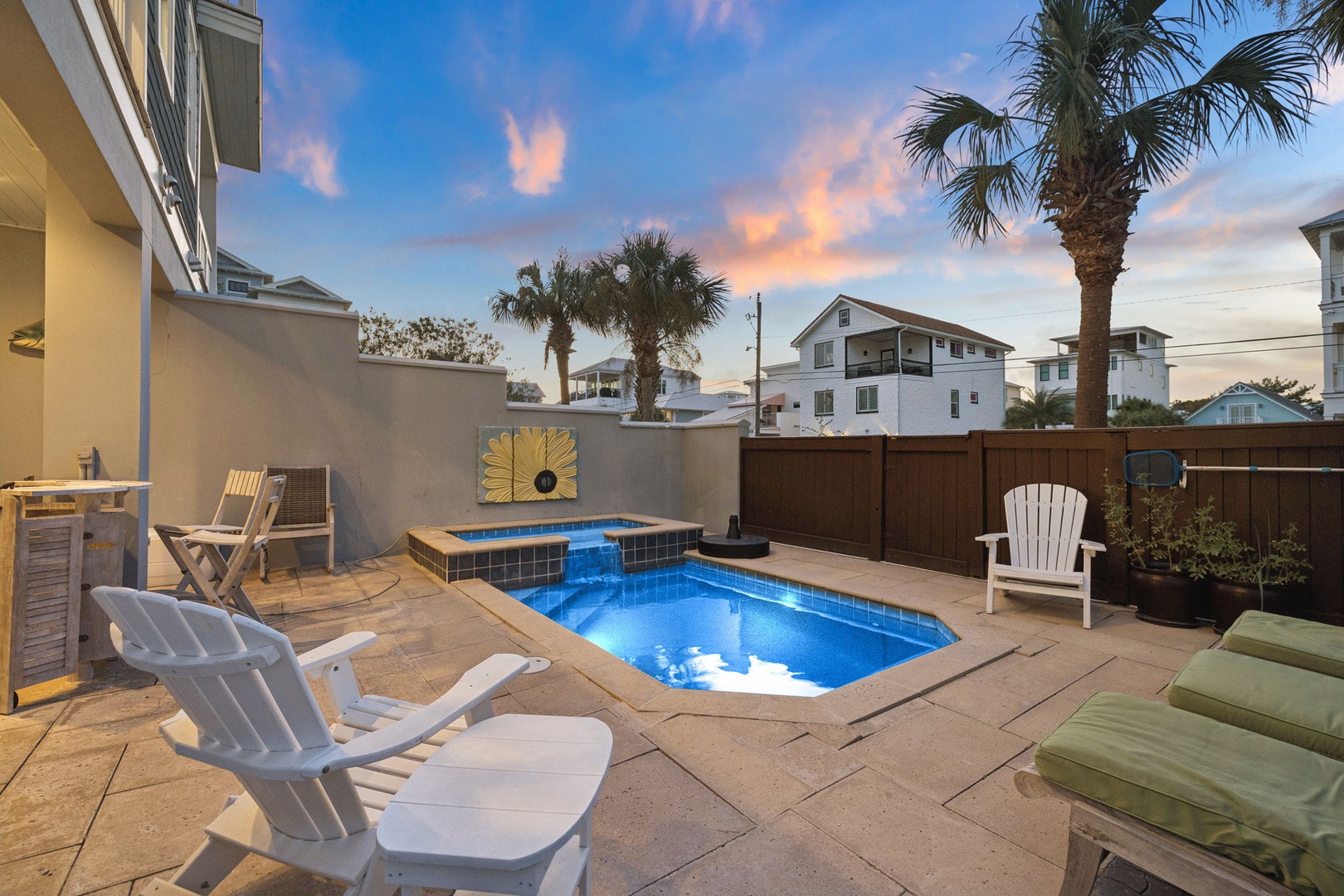 Your own private oasis awaits with a sparkling pool and spa, framed by swaying palms and soft sunset skies—perfect for unwinding after a day at the beach.