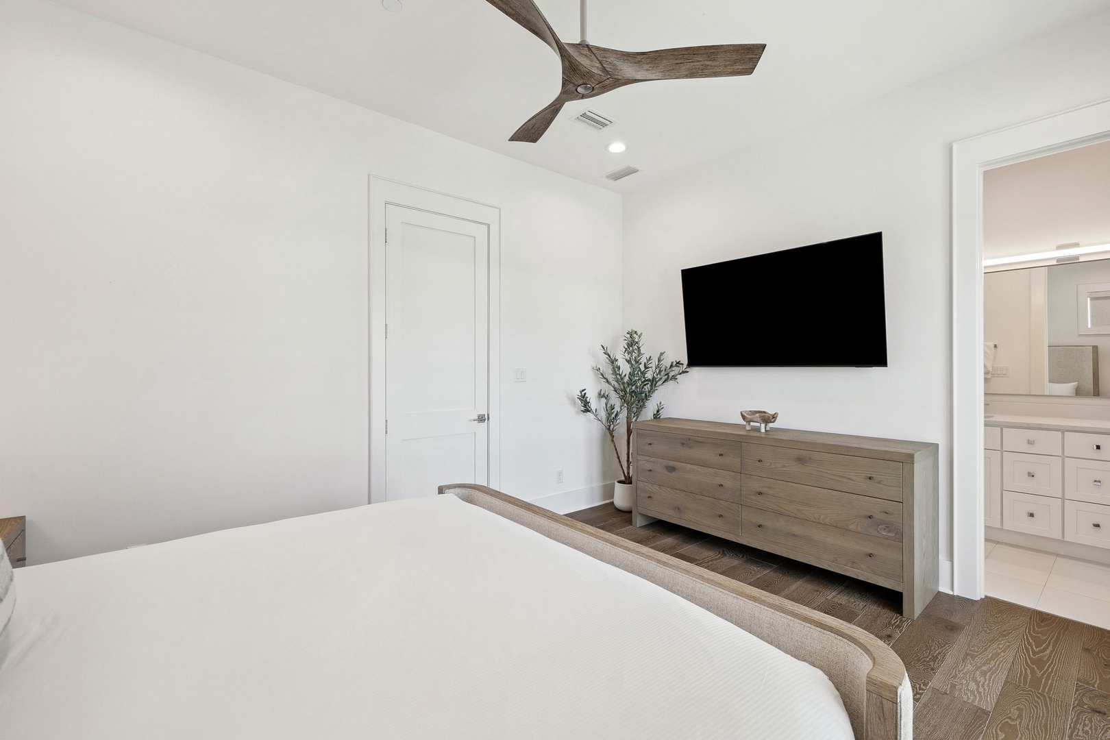 Unwind in your serene bedroom featuring crisp white linens, rustic wood accents, and modern amenities for the perfect restful retreat.