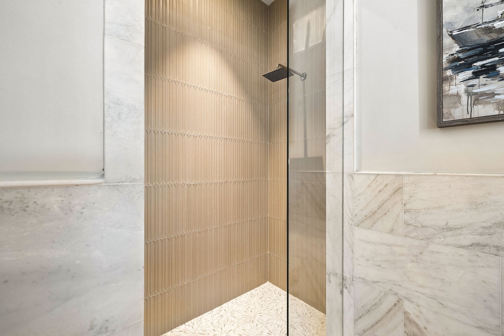 Step into your private spa-like retreat, where elegant textured tiles and a sleek rainfall showerhead create a soothing escape after your day of adventure.