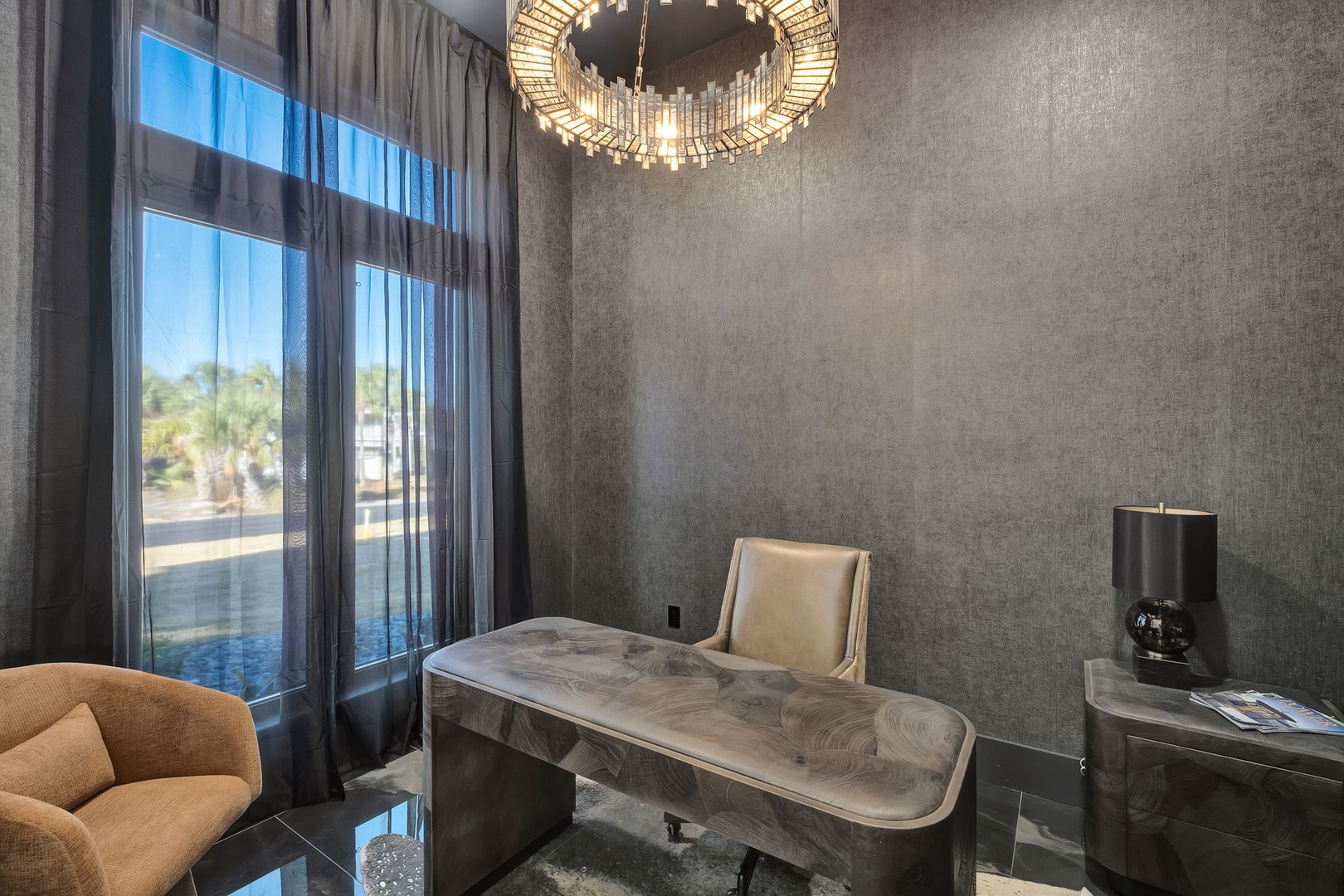 Unwind in your private spa sanctuary with a luxurious massage table, dramatic chandelier, and serene poolside views.