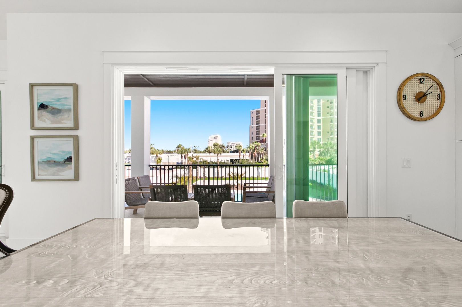 Step through sleek sliding doors to your private balcony, where palm trees sway and coastal views stretch beyond the railing—your perfect spot to unwind after a beach day.