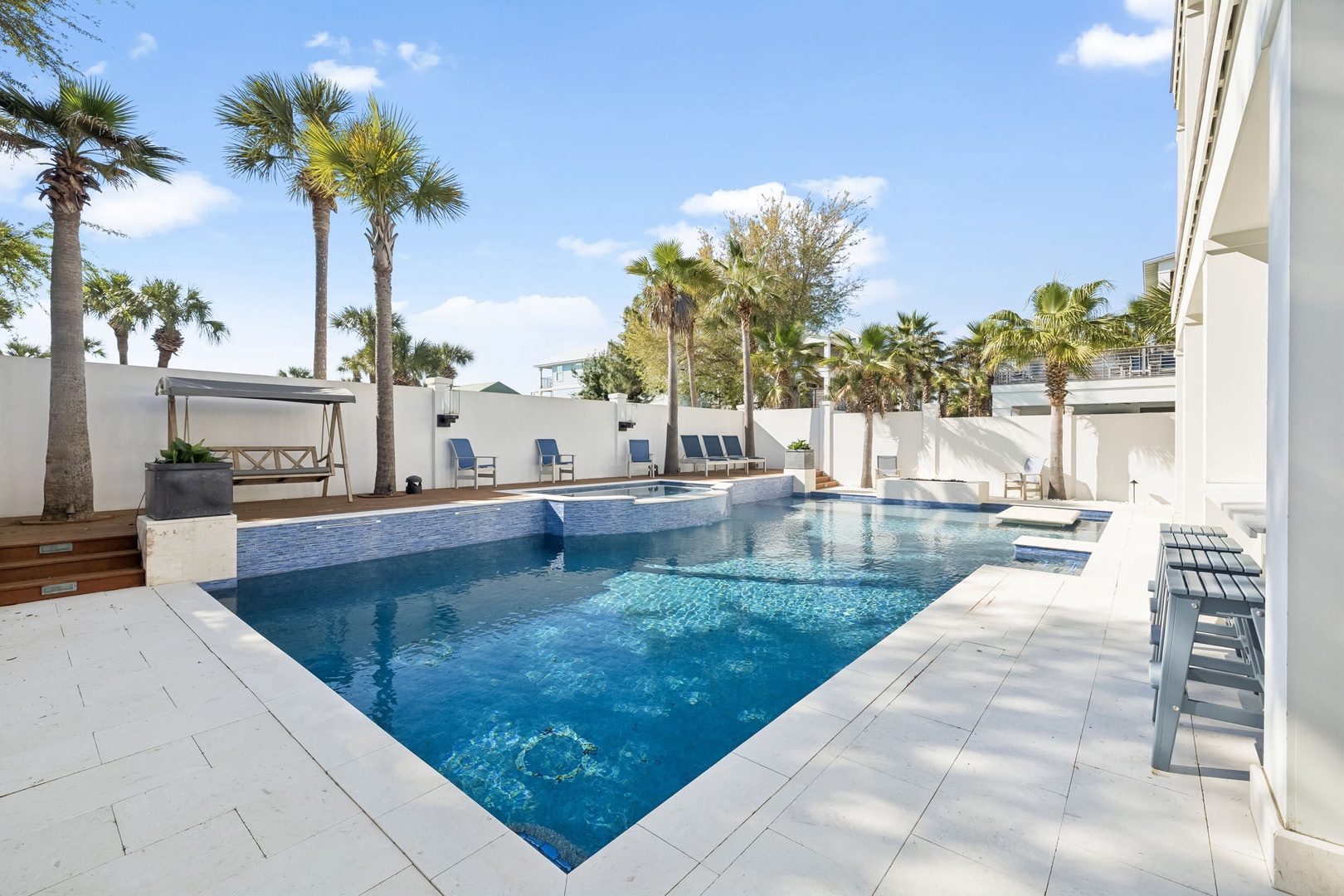 Dive into your private oasis surrounded by swaying palms and endless blue skies in this stunning poolside retreat.
