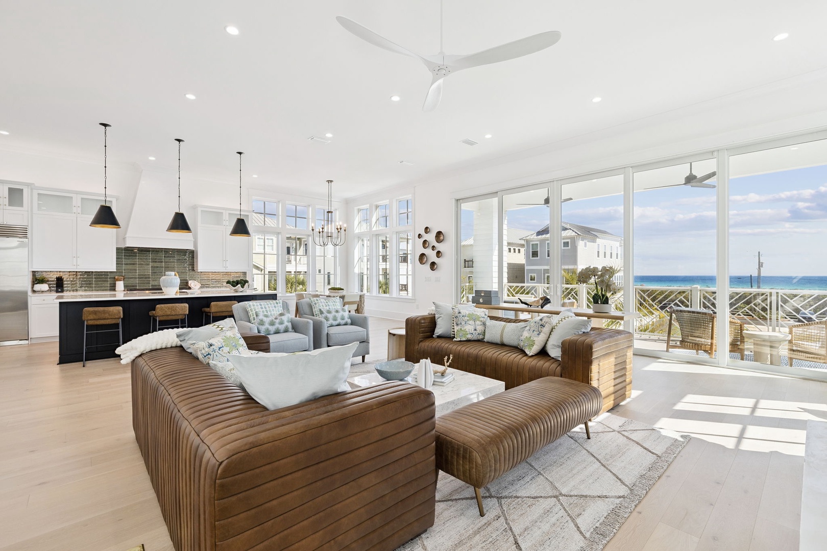 Your breathtaking open-concept living space flows from gourmet kitchen to ocean-view lounge, where leather seating invites relaxation.