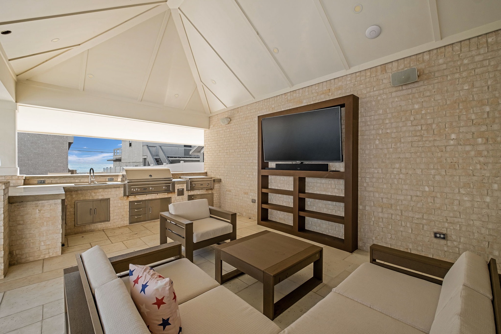 Your rooftop retreat awaits with a fully equipped outdoor kitchen and cozy seating area—perfect for entertaining under vaulted ceilings.