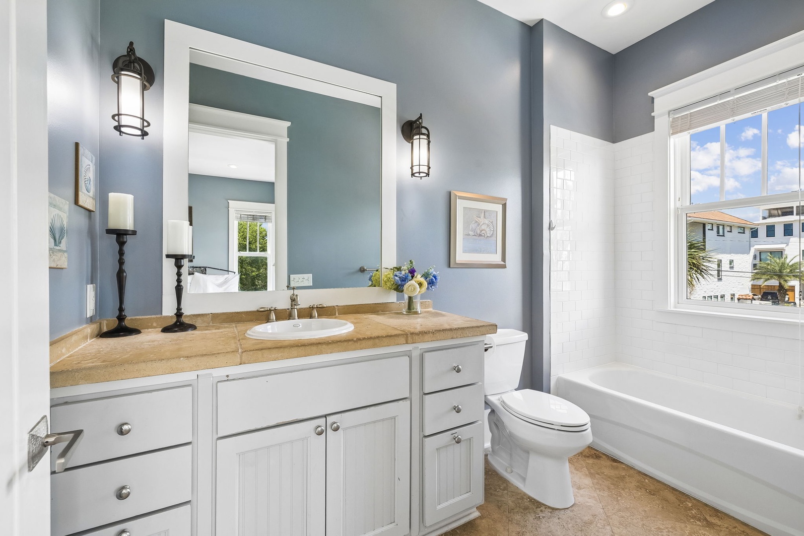 Refresh in your serene bathroom, where calming blue walls and natural light create a peaceful retreat after each day's adventures.