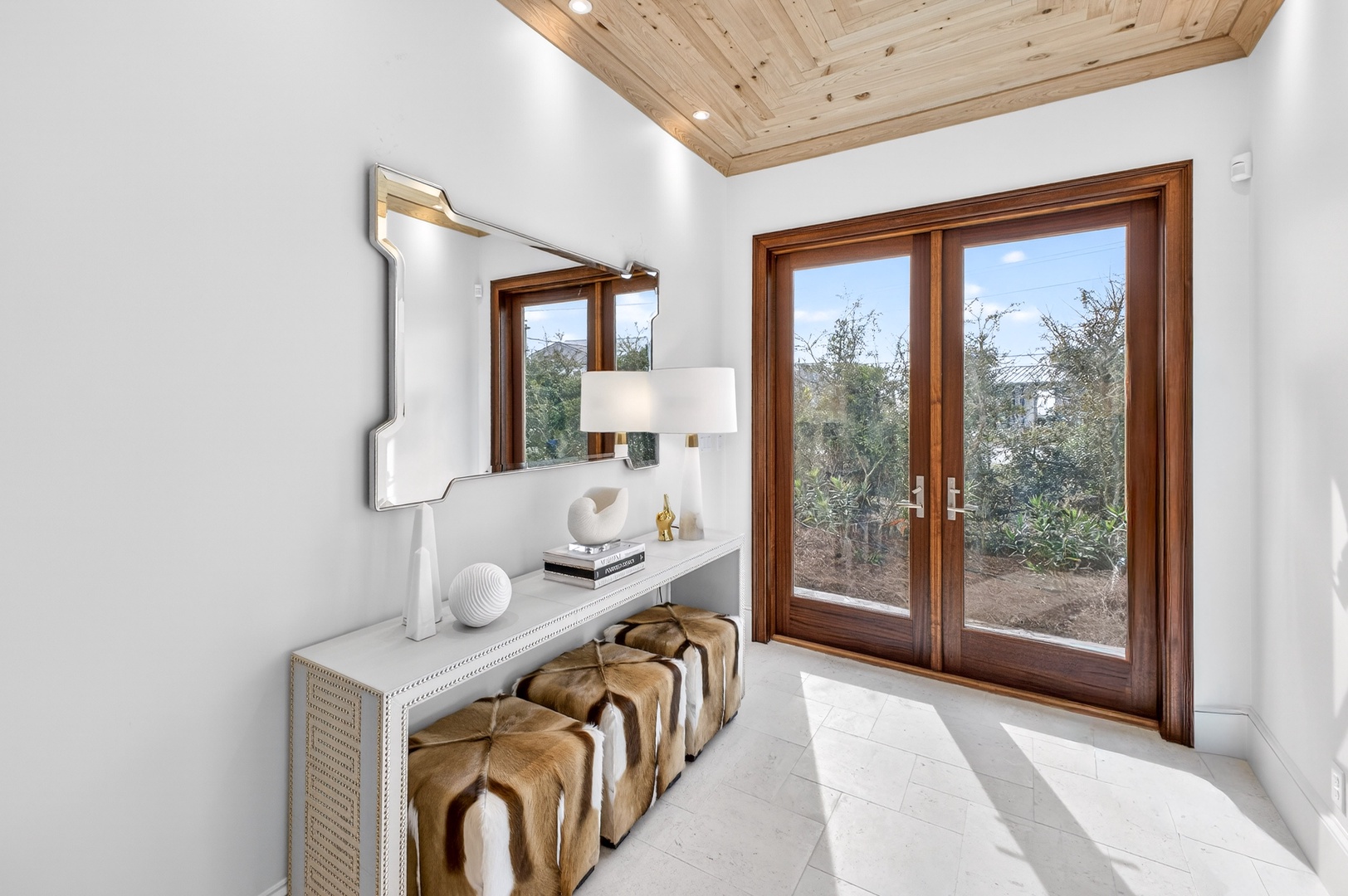 Your private sanctuary features elegant furnishings and warm wood details, with peaceful garden views through sliding glass doors.