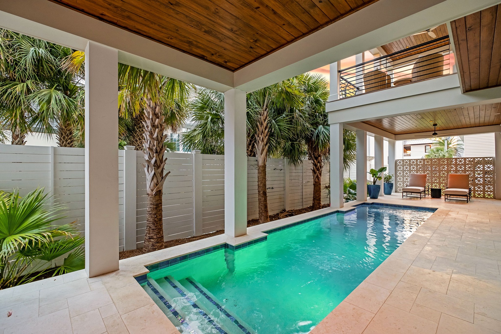 Your private pool oasis awaits, surrounded by swaying palms and warm wood accents for the perfect tropical escape.