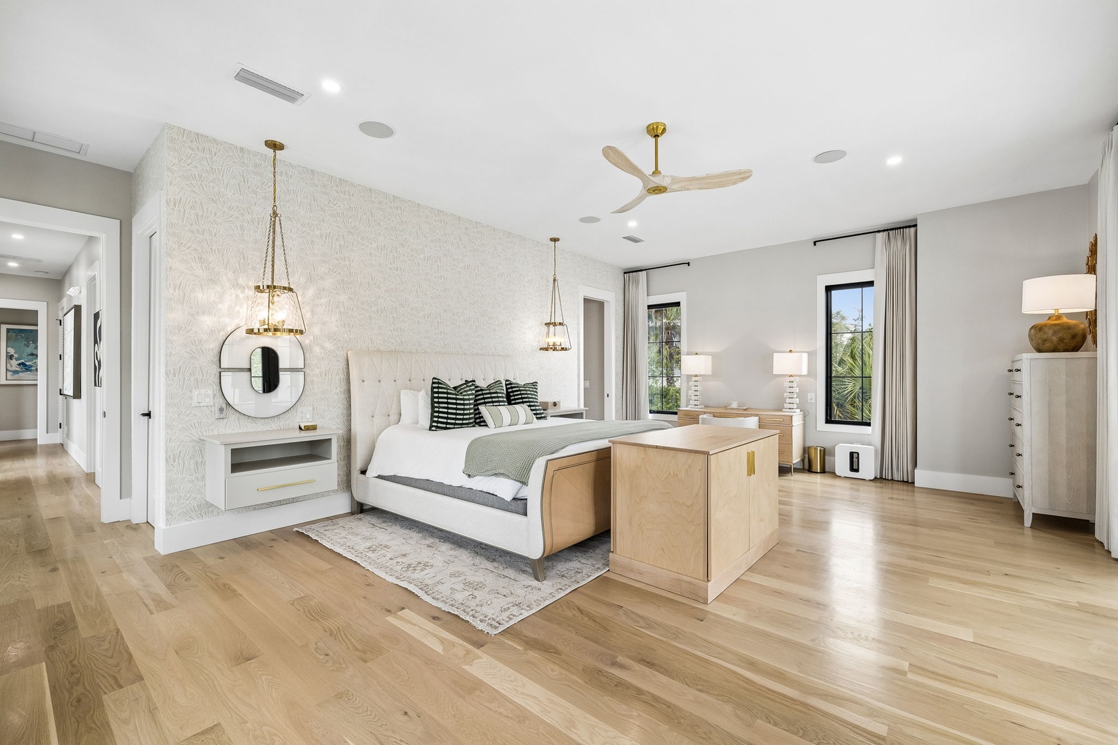 Unwind in your spacious bedroom with plush bedding, warm wood floors, and soft pendant lighting that creates the perfect sanctuary for restful nights.