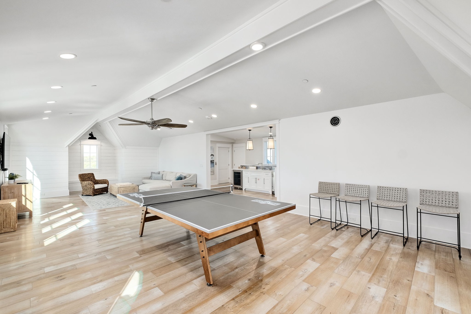 Your spacious game loft features gleaming hardwood floors, a sleek ping pong table, and cozy seating—perfect for fun-filled evenings with friends.