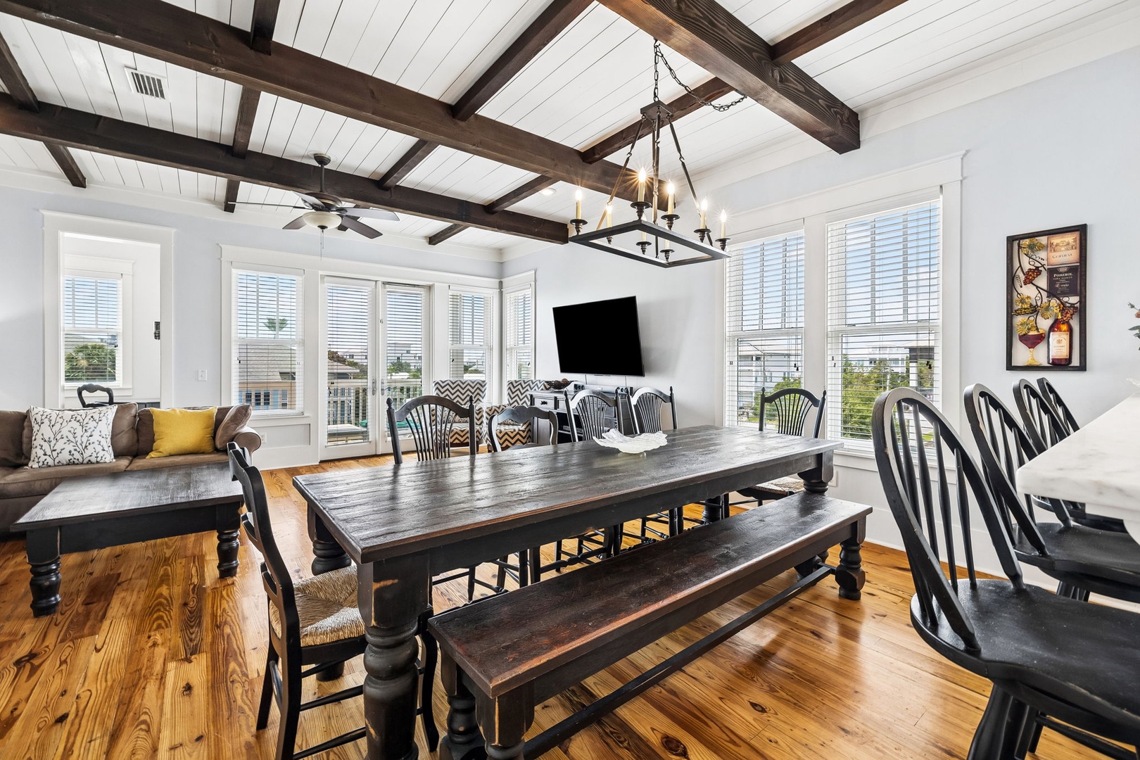 Gather around this spacious dining table under beautiful exposed beams, with plenty of room for your whole group to share meals and make memories together.