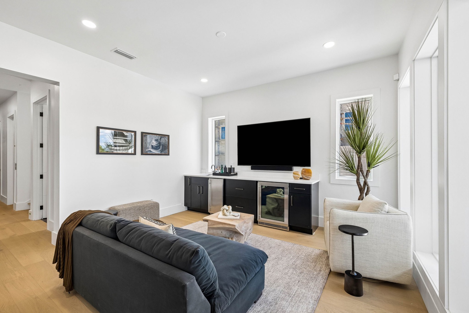 Sink into the plush sofa and unwind in this bright, modern living space designed for your comfort and relaxation.