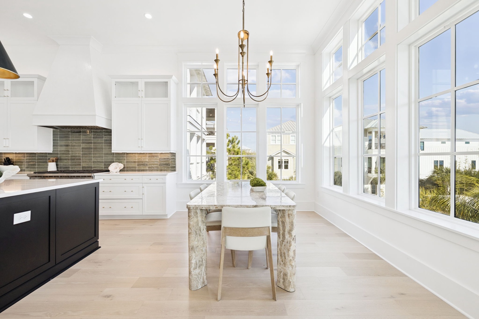 Your gourmet kitchen features sleek marble countertops and floor-to-ceiling windows that flood the space with natural light.