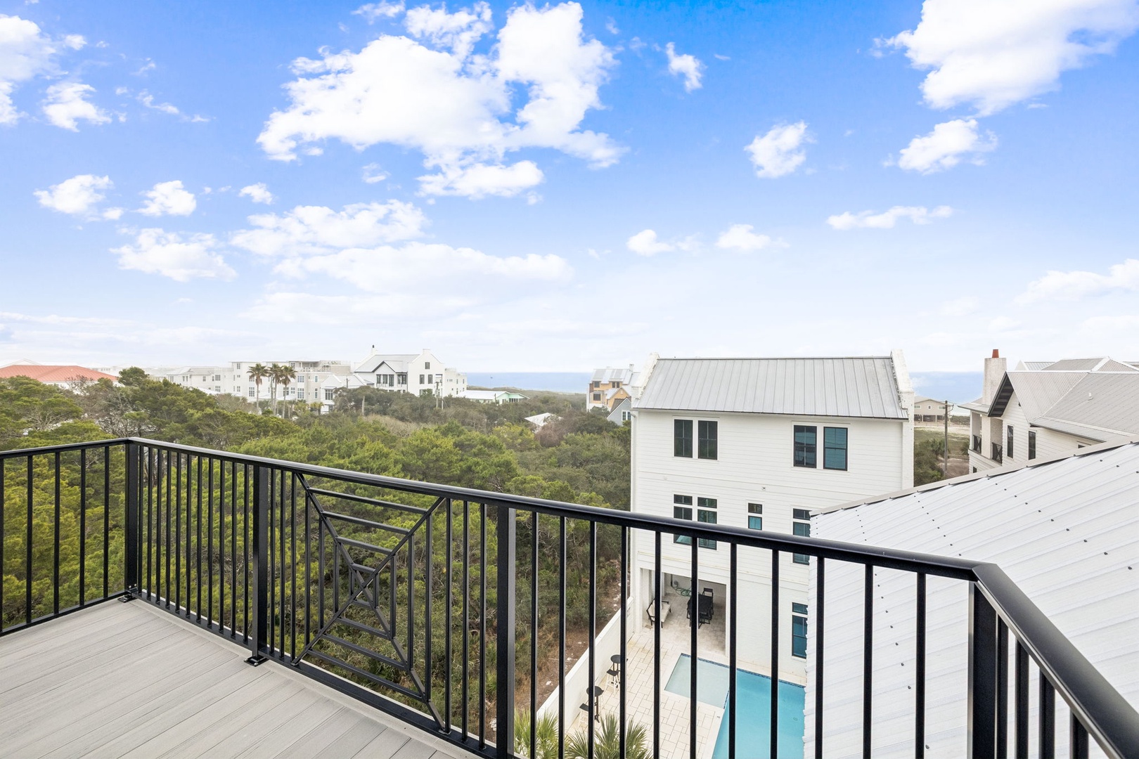 Step onto your private balcony and soak in sweeping views of coastal homes, lush greenery, and endless blue skies above.