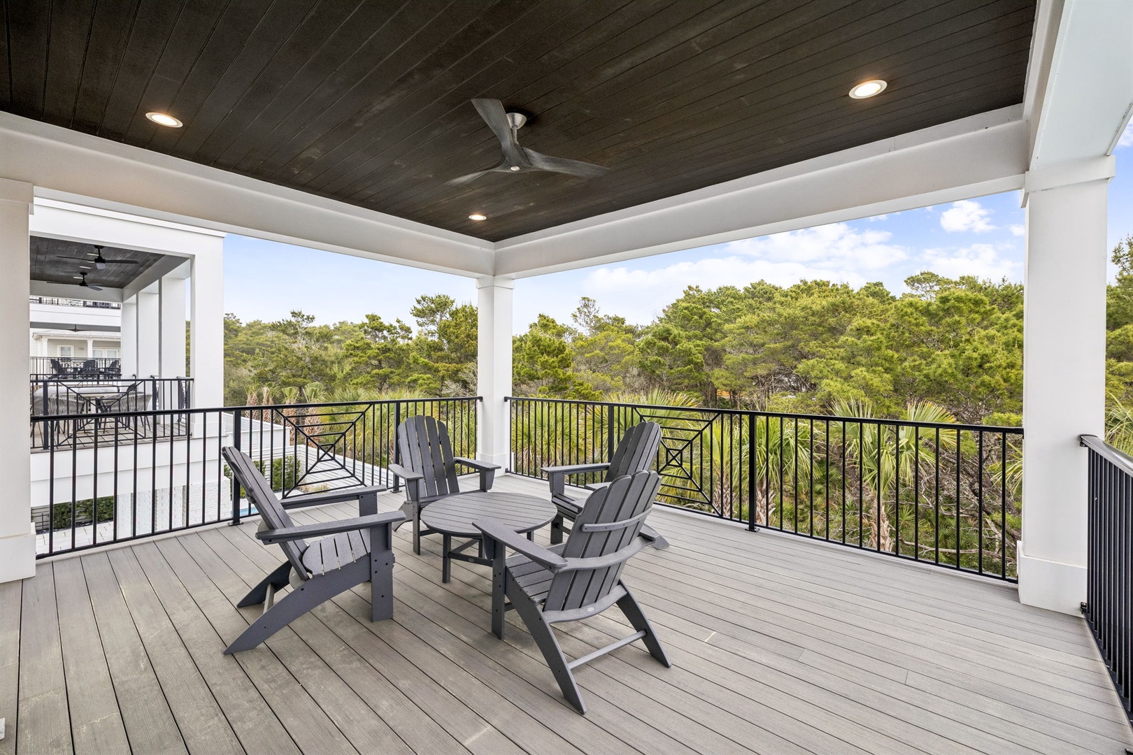 Your private covered balcony offers peaceful forest views with comfortable seating to unwind after exploring.