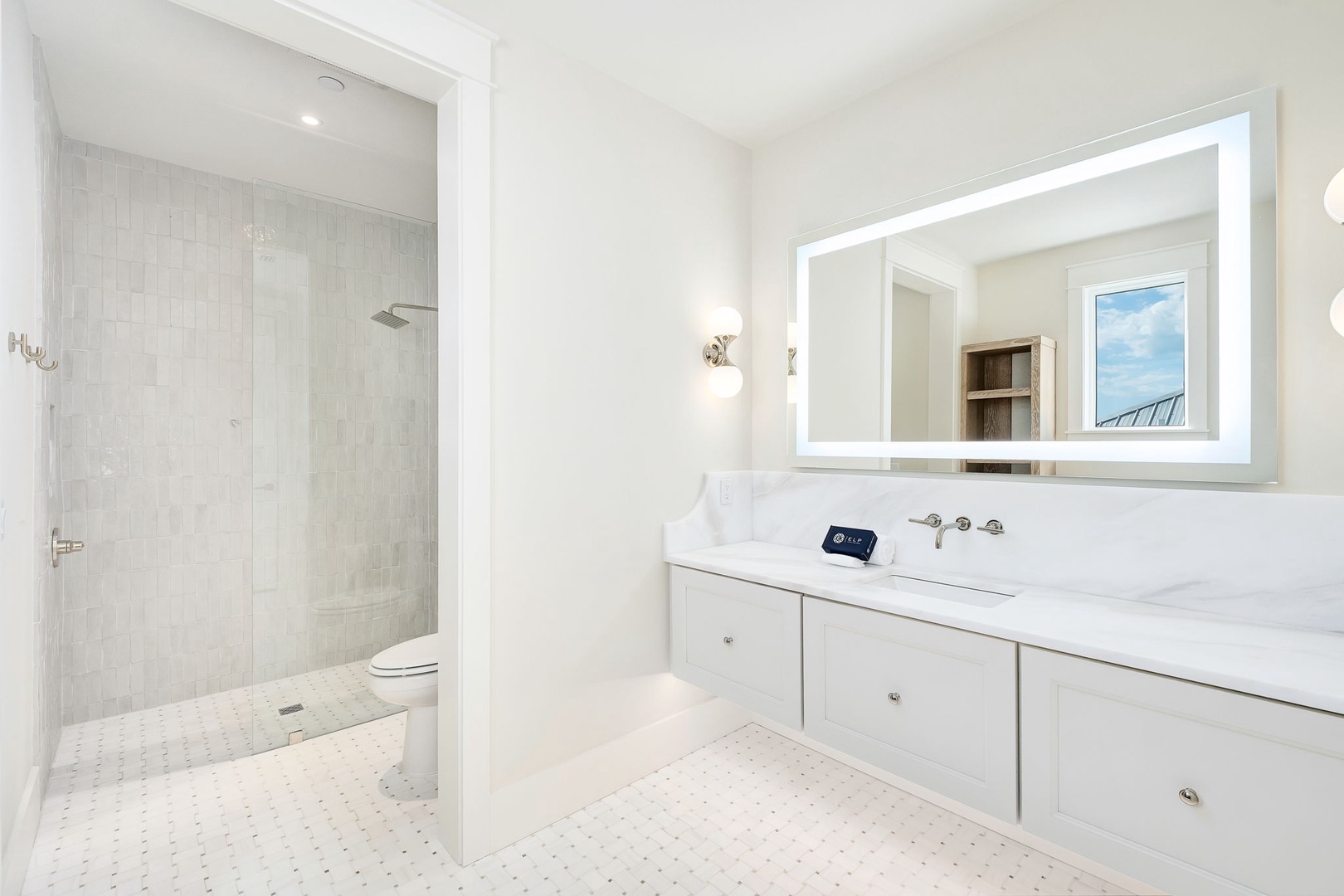Step into your bright, elegant ensuite where crisp white marble and soft subway tiles create a serene spa-like retreat just for you.