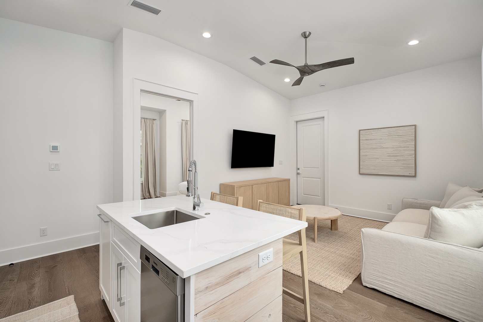 Your bright, modern suite features an open kitchen island perfect for morning coffee while you watch your favorite shows on the wall-mounted TV.