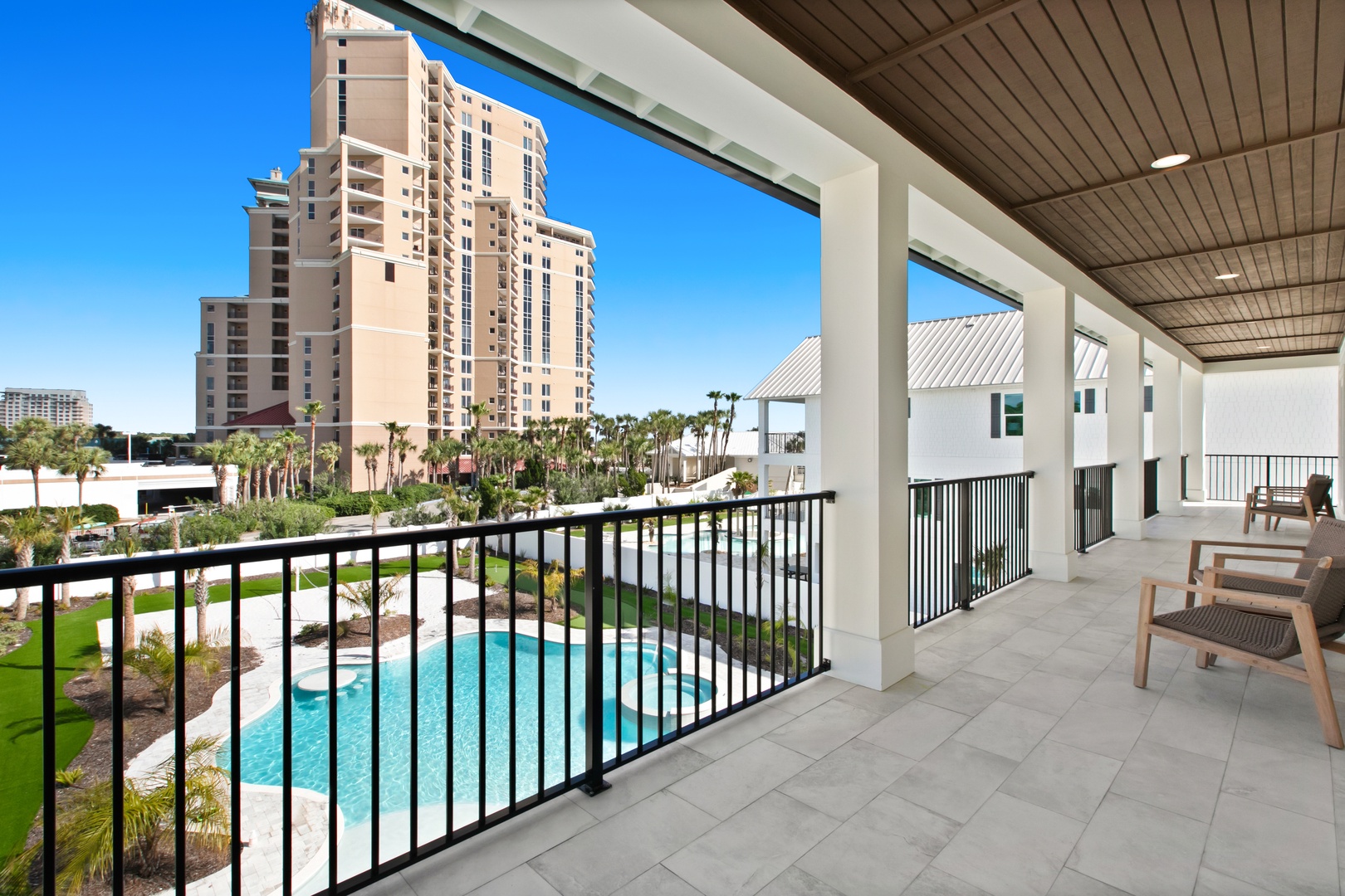 Picture yourself unwinding on your private balcony, where palm trees sway below and the sparkling pool invites you to take a refreshing dip. Modern comfort meets resort-style living right at your doorstep.