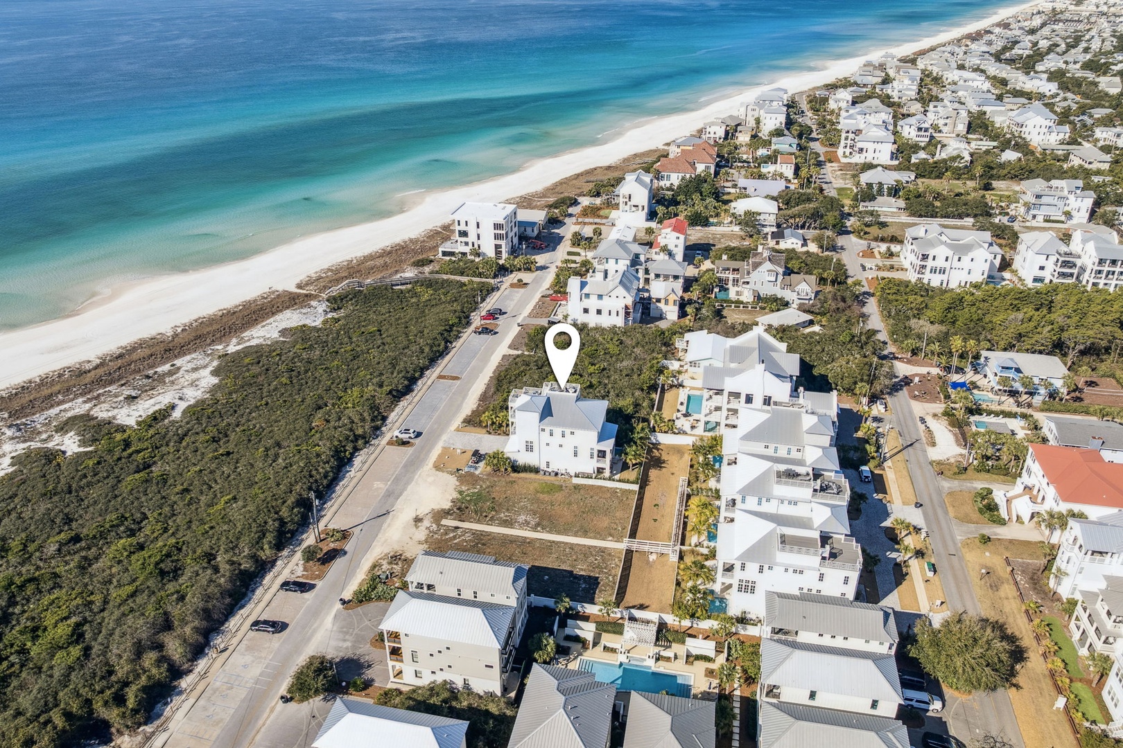 Beachfront community with white sand beach and turquoise waters just steps from residential neighborhood.