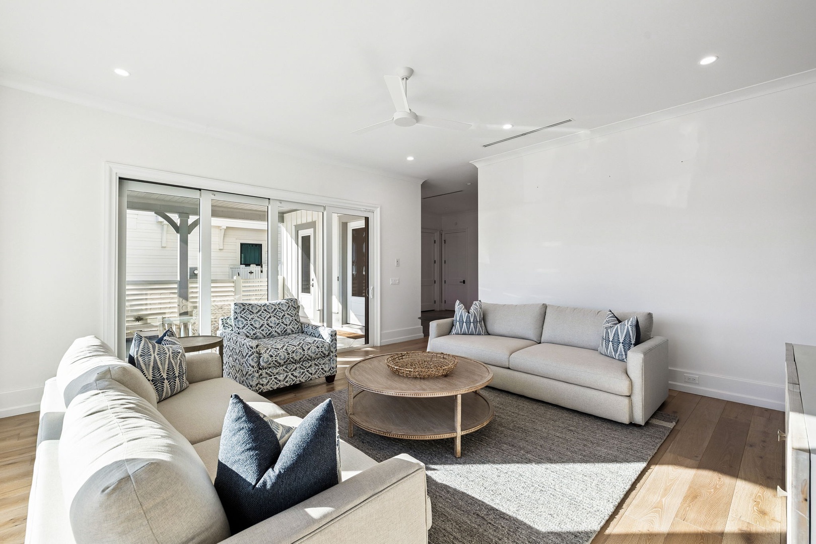 Sink into plush sofas in your bright living space, where natural light streams through sliding doors to your private patio.