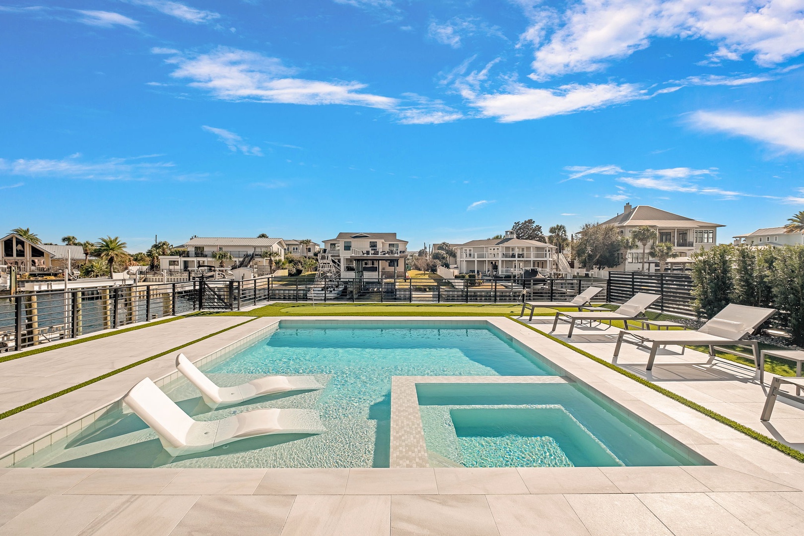 Dive into your private oasis with this stunning multi-level pool featuring shallow lounging areas and deeper swimming zones, perfect for relaxation.