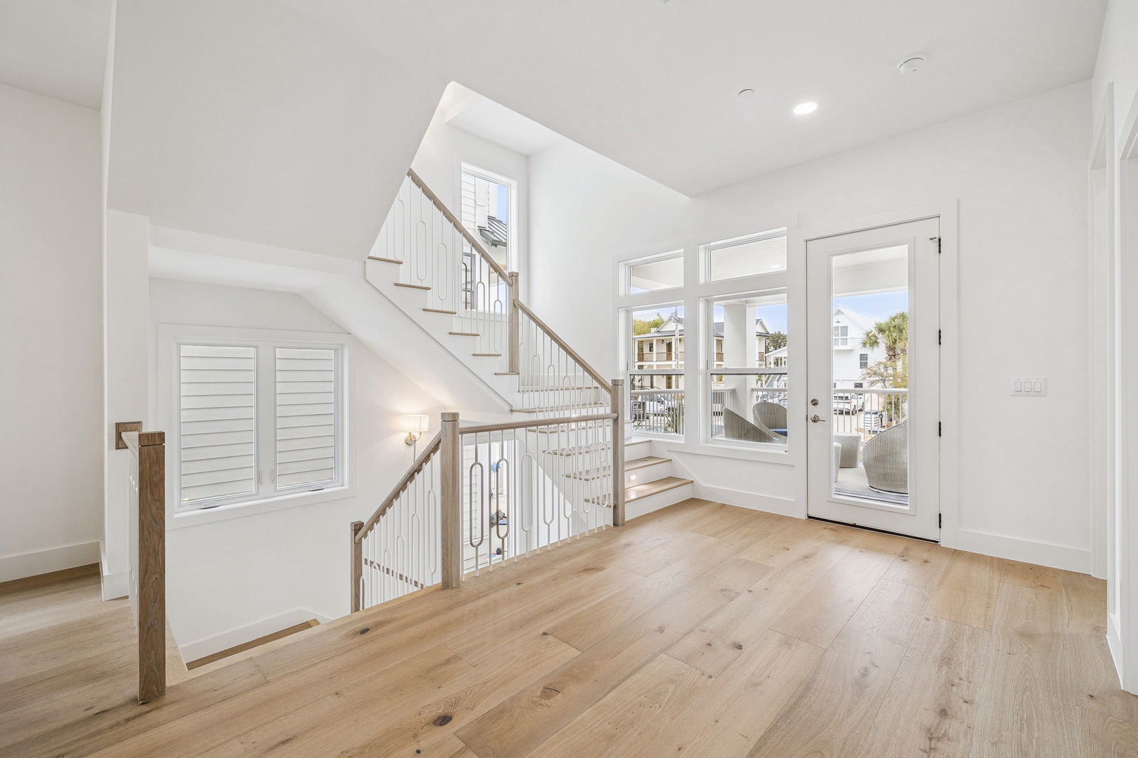 Bright, airy entryway with gleaming hardwood floors welcomes you home, while French doors reveal your private balcony overlooking coastal surroundings.