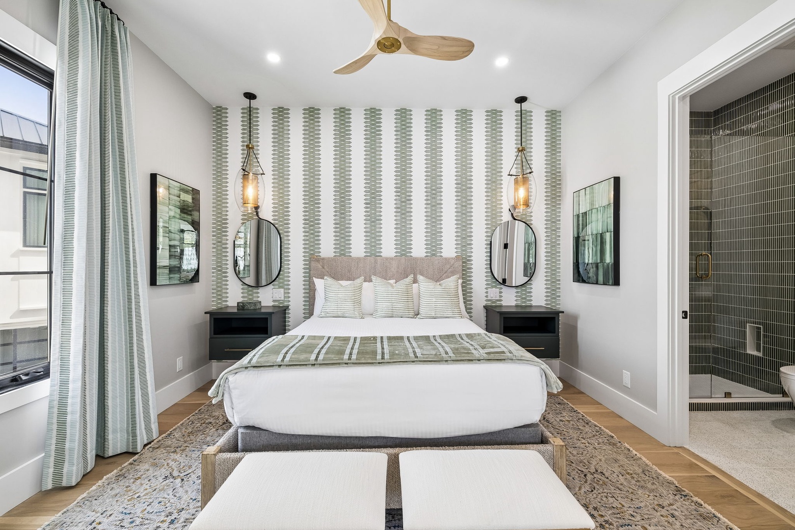 Picture yourself waking in this serene retreat, where soothing stripes and warm wood tones create your perfect escape. The plush bed and calming colors promise peaceful mornings and restful nights.