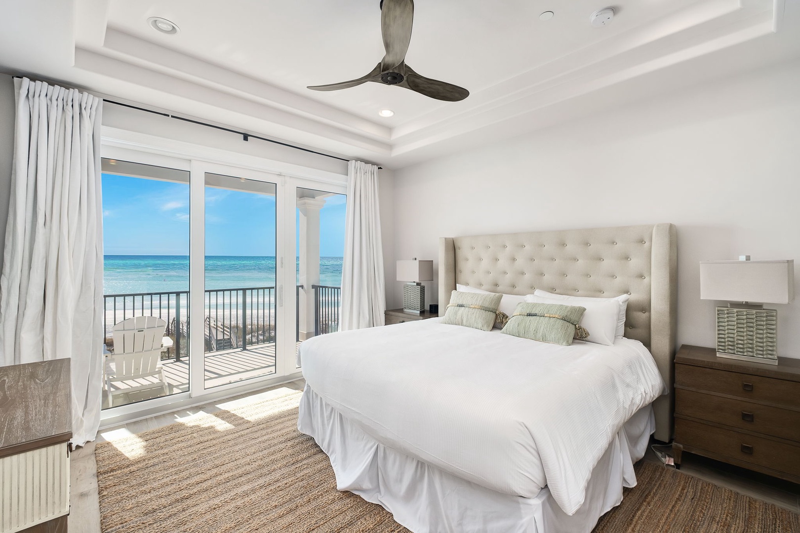 Wake up to stunning ocean views from your beachfront bedroom, where crisp white linens and coastal breezes create pure serenity.