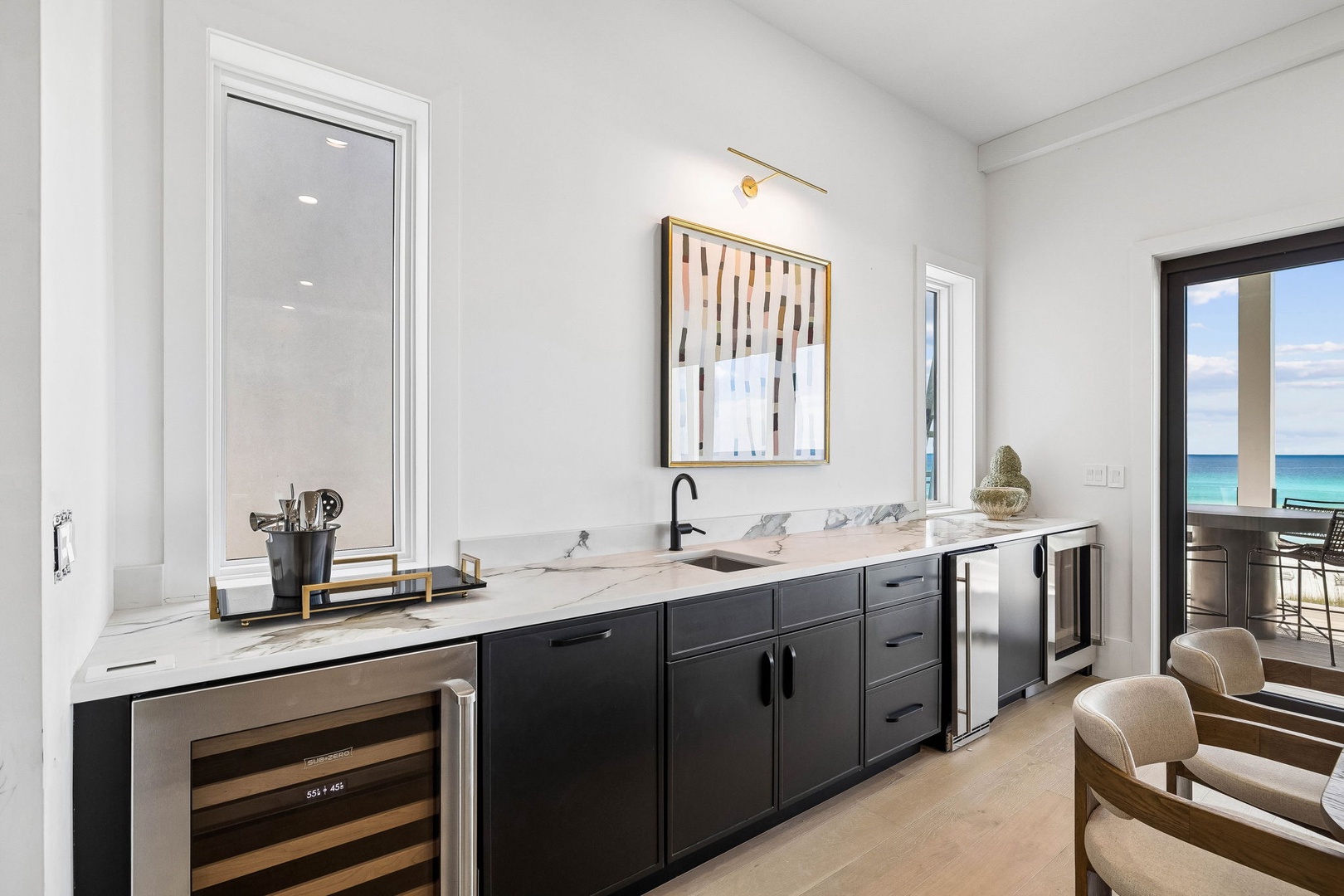 Your sleek kitchenette features marble countertops and everything you need for easy entertaining, with stunning ocean views framed through glass doors.